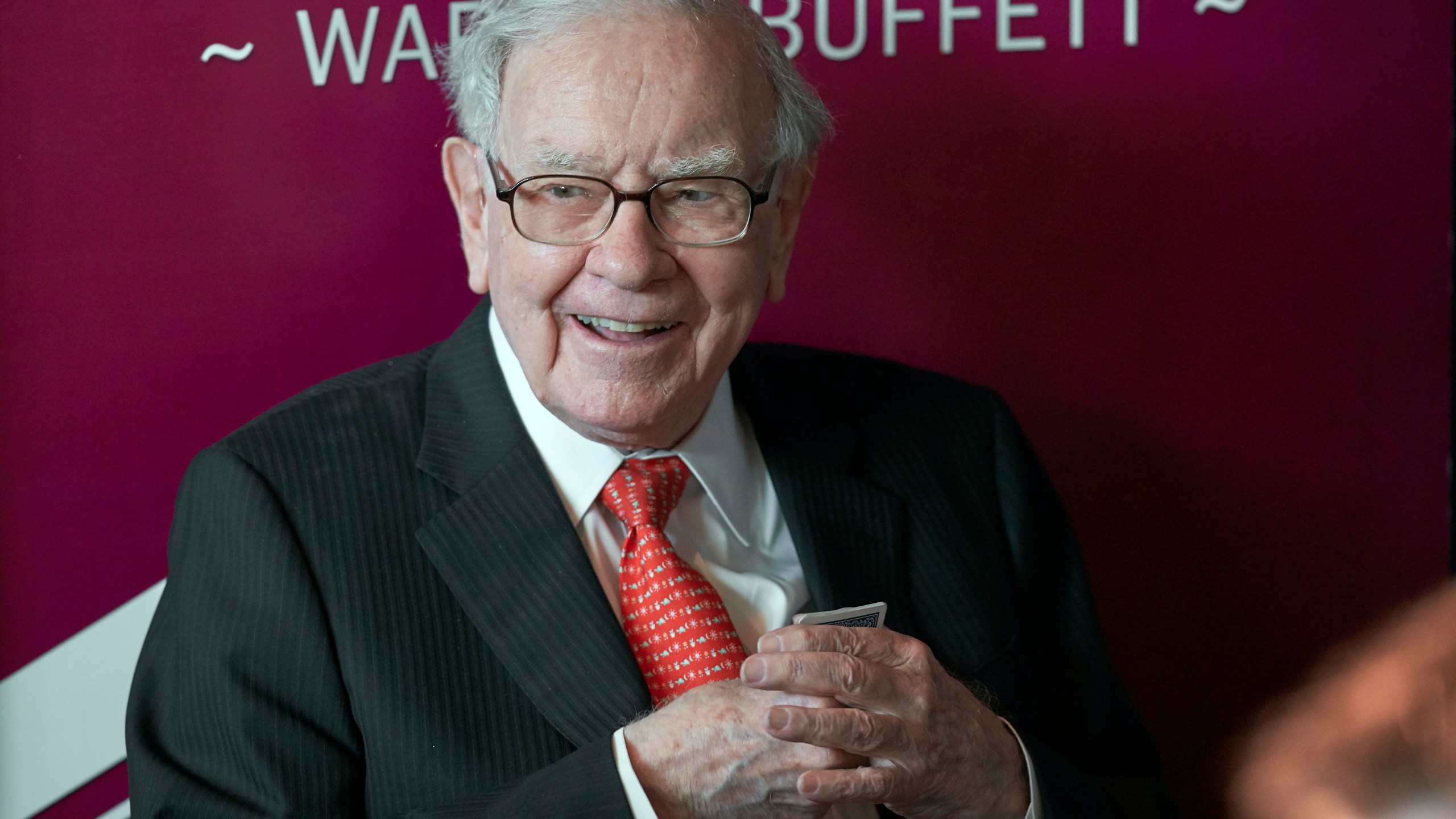 FILE - Warren Buffett, chairman and CEO of Berkshire Hathaway, smiles as he plays bridge following the annual Berkshire Hathaway shareholders meeting in Omaha, Neb., May 5, 2019. (AP Photo/Nati Harnik, File)