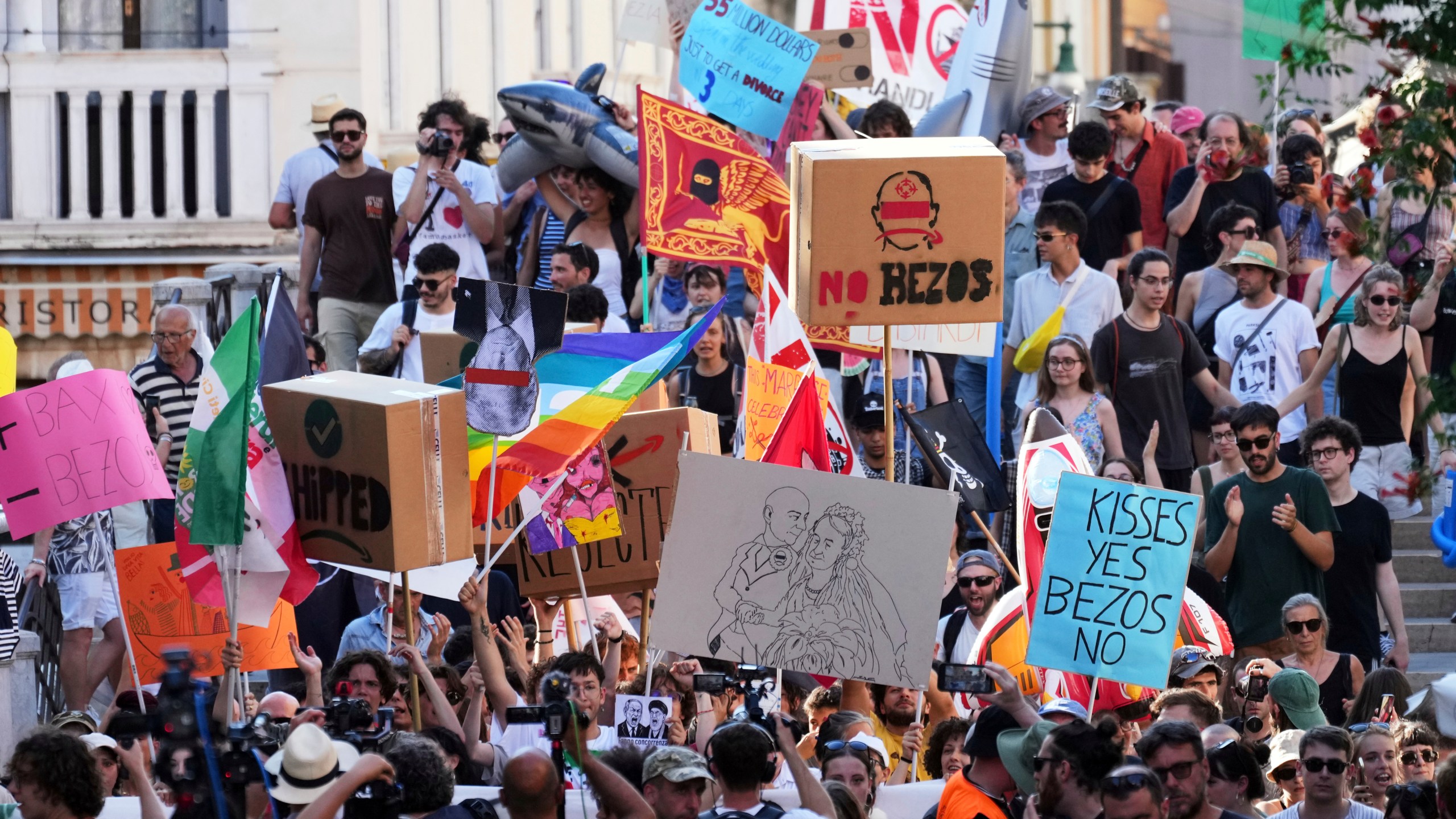 Activists stage a protest in Venice, Italy, Saturday, June 28, 2025, denouncing the three-day celebrations for the wedding between Jeff Bezos and his wife Lauren Sanchez Bezos that took place in Venice on Friday as a symbol of rising inequality and disregard for the city's residents. (AP Photo/Antonio Calanni)