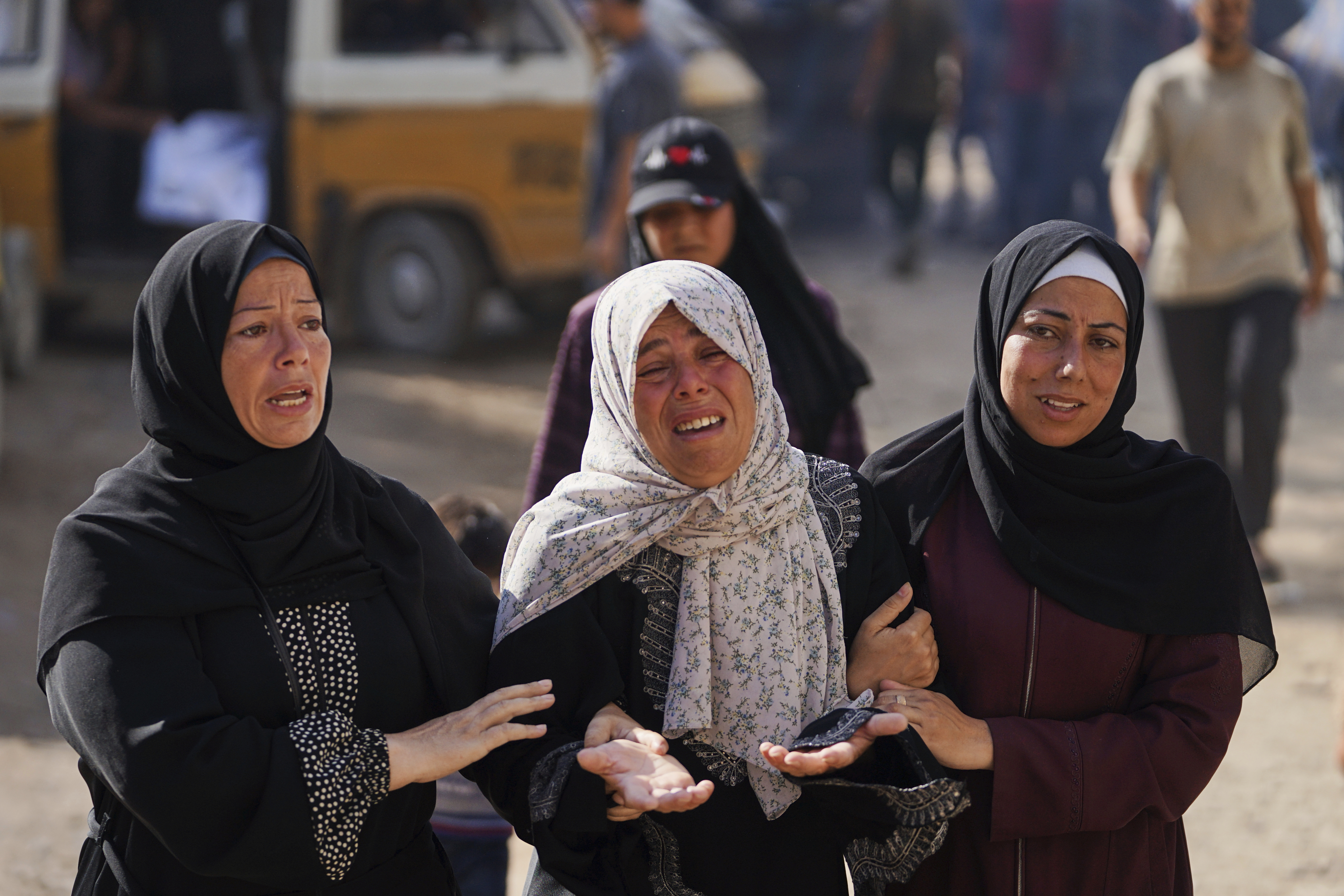 Relatives of Palestinians killed in Israeli strikes on the Gaza Strip mourn their deaths at Al-Shifa Hospital in Gaza City, Saturday, June 28, 2025. (AP Photo/Jehad Alshrafi)