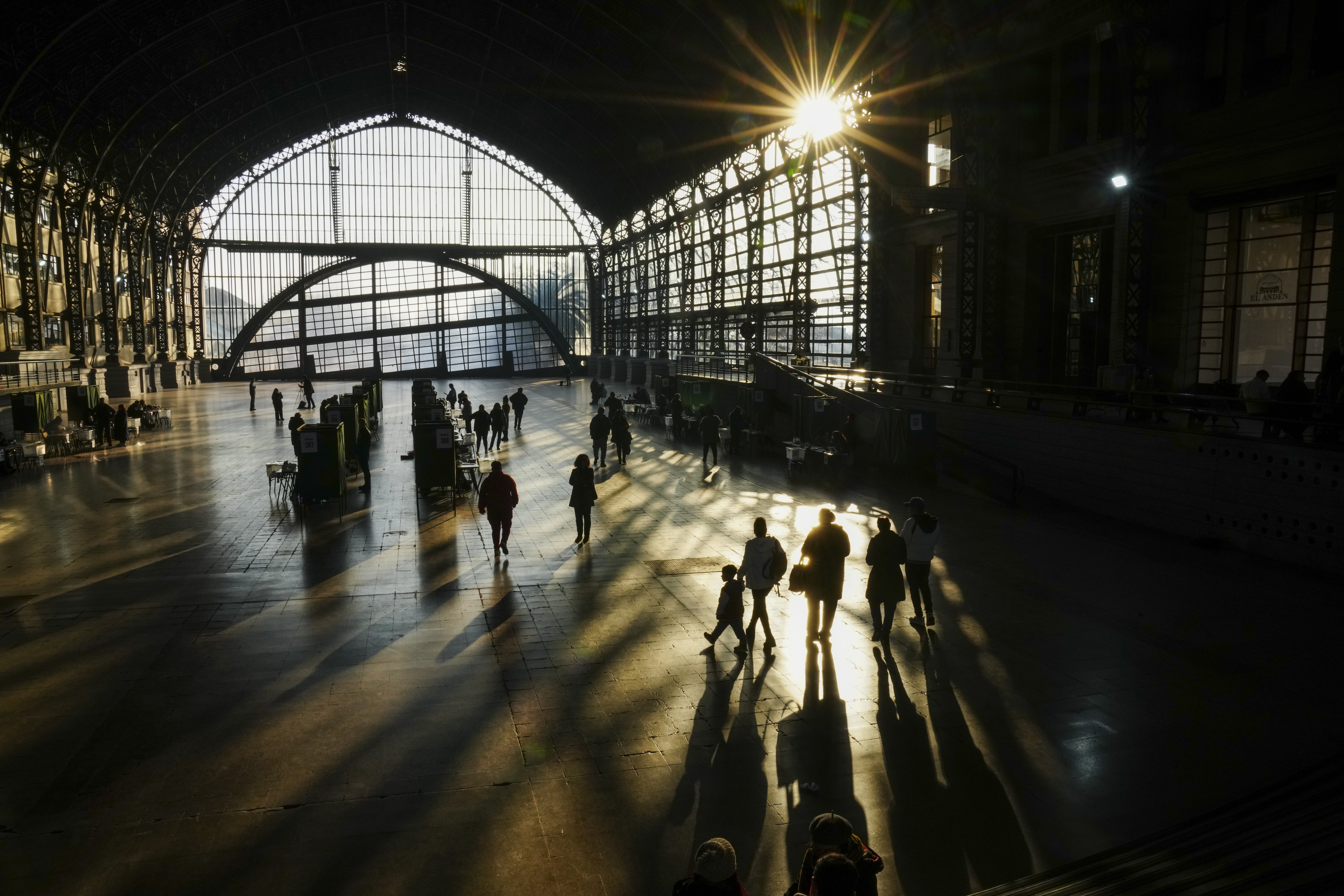 People head to cast their ballots in the former Mapocho railway station during a primary held by the Unidos por Chile coalition to choose the ruling party's candidate for the upcoming presidential election, in Santiago, Chile, Sunday, June 29, 2025. (AP Photo/Esteban Felix)