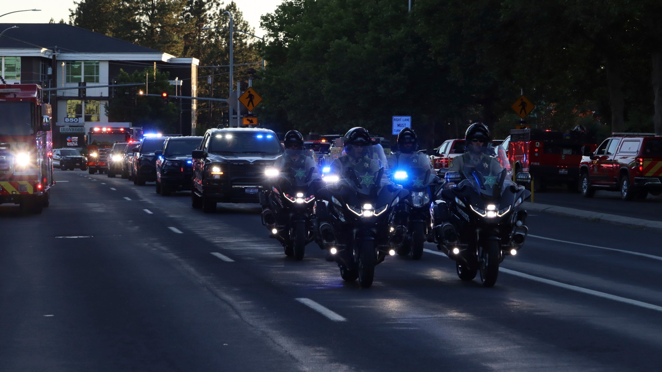 A procession from Kootenai Health headed to Spokane after a few firefighters were killed Sunday, June 29, 2025, when they were ambushed by sniper fire while responding to a blaze in a northern Idaho mountain community, in Coeur d’Alene, Idaho. (Bill Buley/Coeur D'Alene Press via AP)/