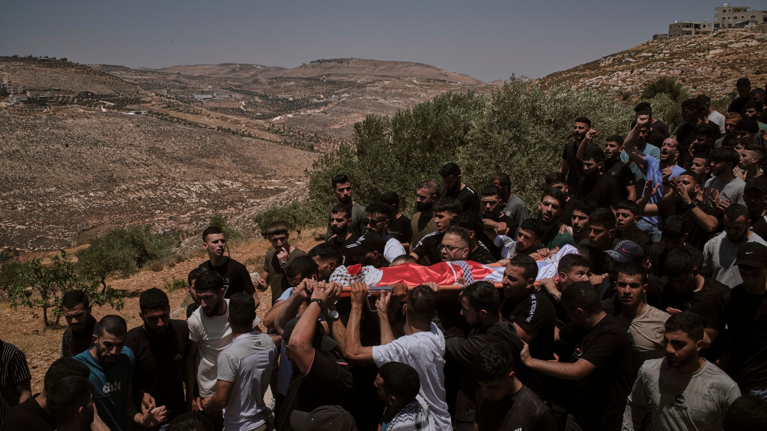 Mourners carry the bodies of three Palestinians who were killed on Wednesday when Jewish settlers stormed the West Bank village of Kafr Malik, Thursday, June 26, 2025. (AP Photo/Leo Correa)