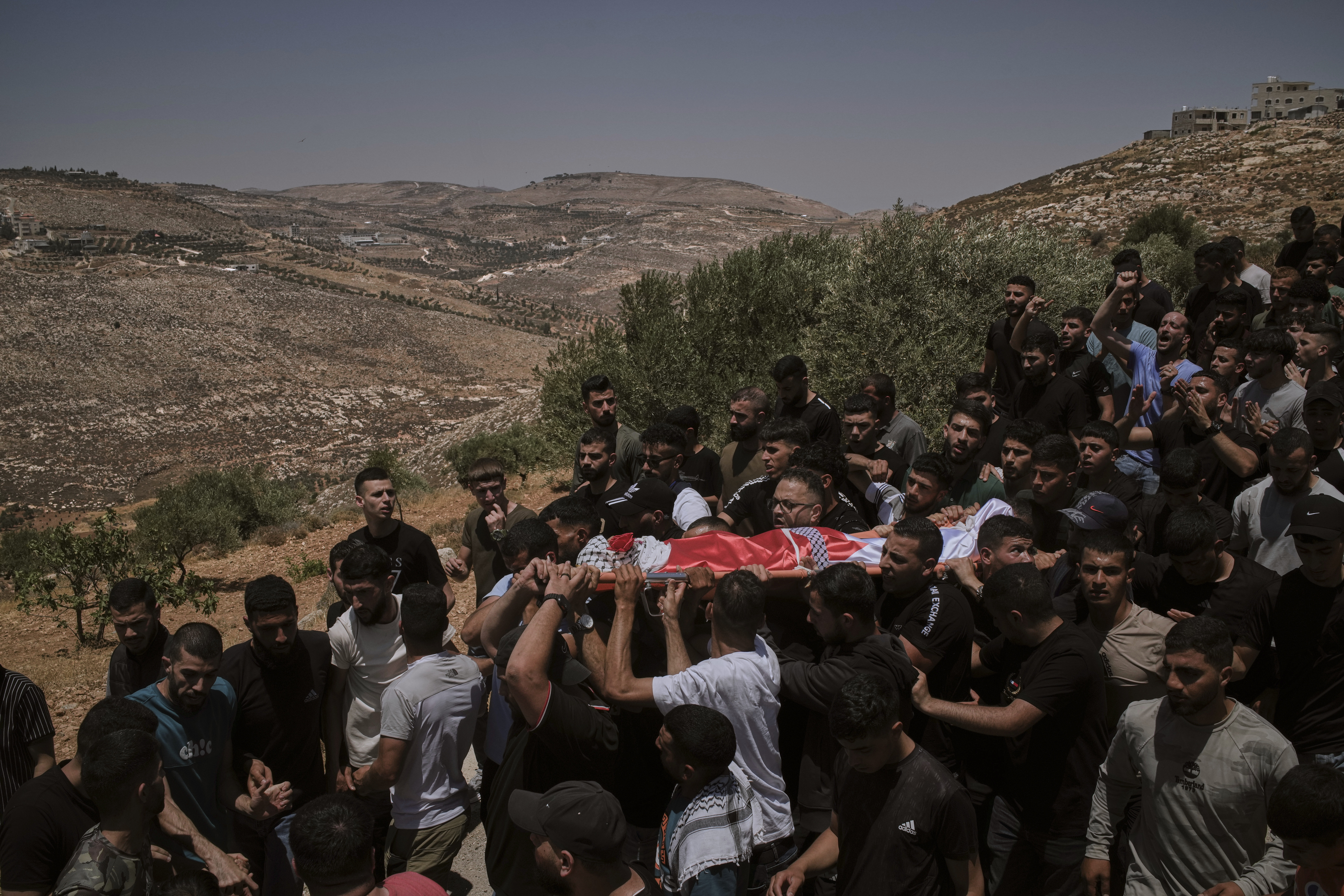 Mourners carry the bodies of three Palestinians who were killed on Wednesday when Jewish settlers stormed the West Bank village of Kafr Malik, Thursday, June 26, 2025. (AP Photo/Leo Correa)