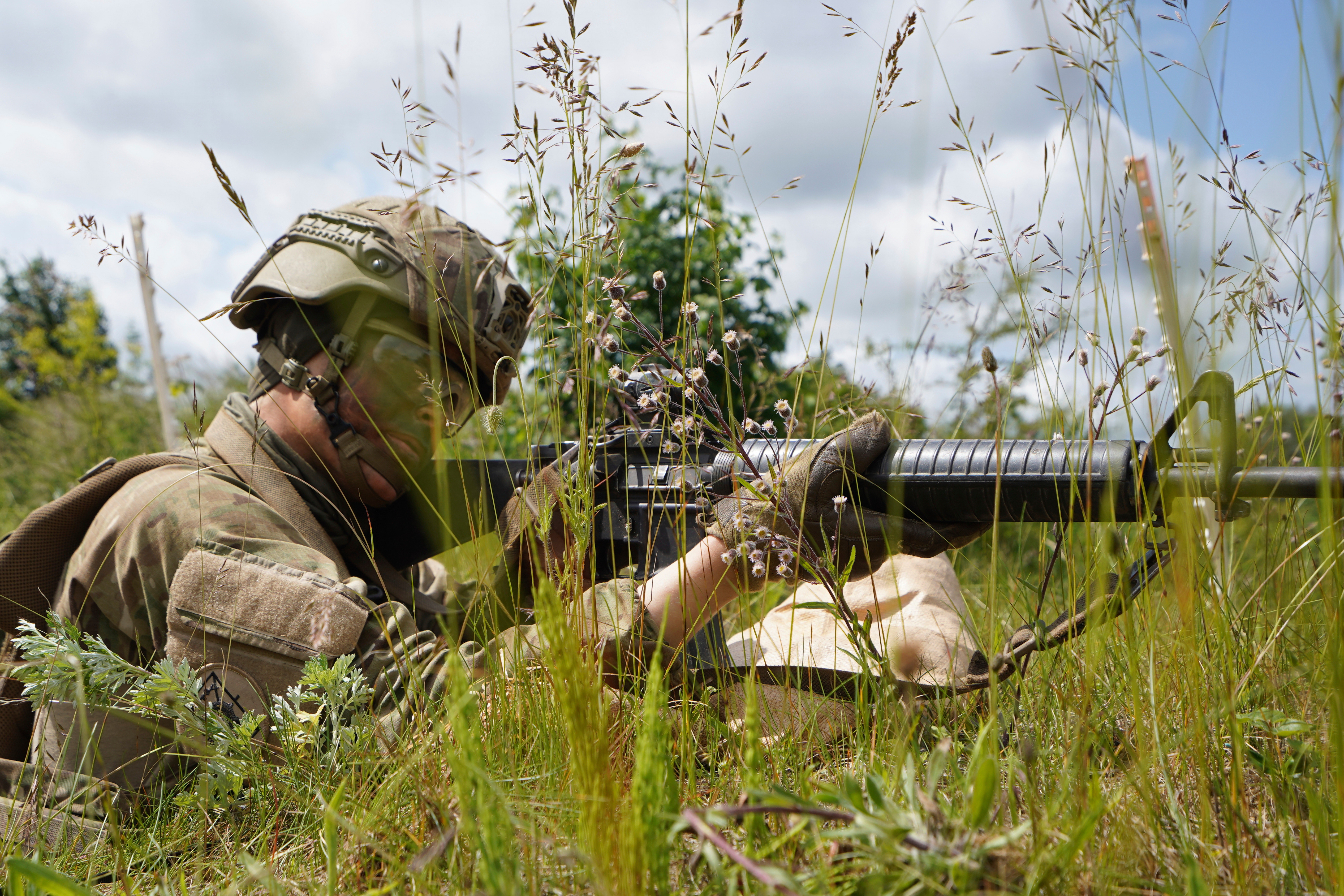 CORRECTS THE NAME OF PERSON'S ROLE A young servecemember aims his rifle during final exercises at a training area close to Royal Danish Army’s barracks in Hovelte, 25 kilometres north of Copenhagen, Denmark, Wednesday, June 11, 2025. (AP Photo/James Brooks)
