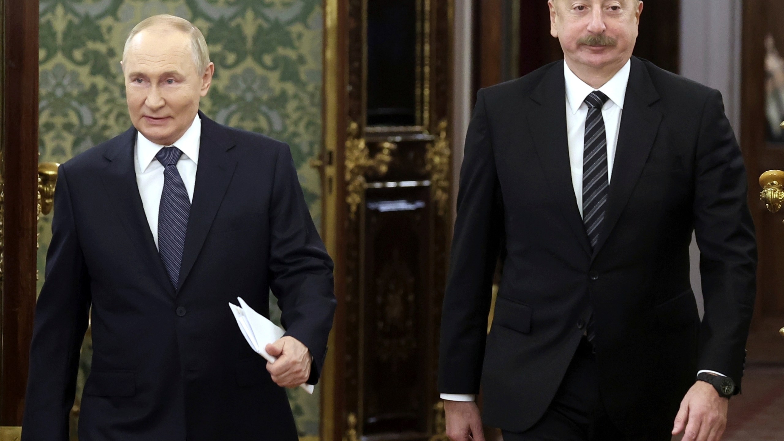 FILE - Russian President Vladimir Putin, left, and Azerbaijani President Ilham Aliyev enter a hall during a meeting at the Kremlin in Moscow, Russia, Oct. 8, 2024. (Valery Sharifulin, Sputnik, Kremlin Pool Photo via AP, File)