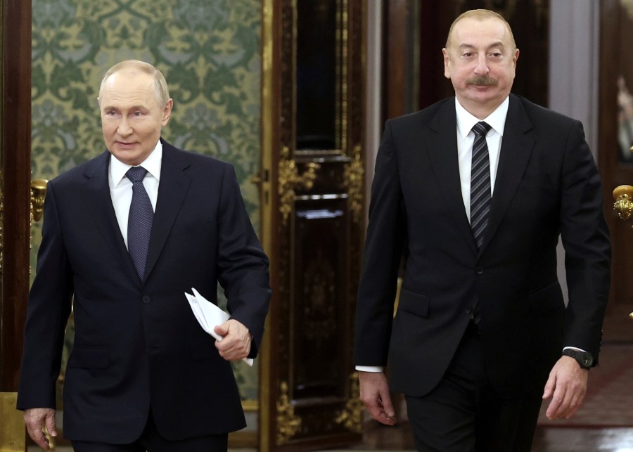 FILE - Russian President Vladimir Putin, left, and Azerbaijani President Ilham Aliyev enter a hall during a meeting at the Kremlin in Moscow, Russia, Oct. 8, 2024. (Valery Sharifulin, Sputnik, Kremlin Pool Photo via AP, File)