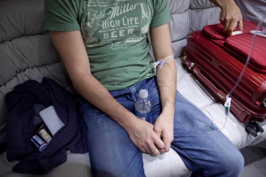A patient is hooked up to an IV for a hangover treatment in Las Vegas on Sunday, April 15, 2012. (AP Photo/Julie Jacobson)