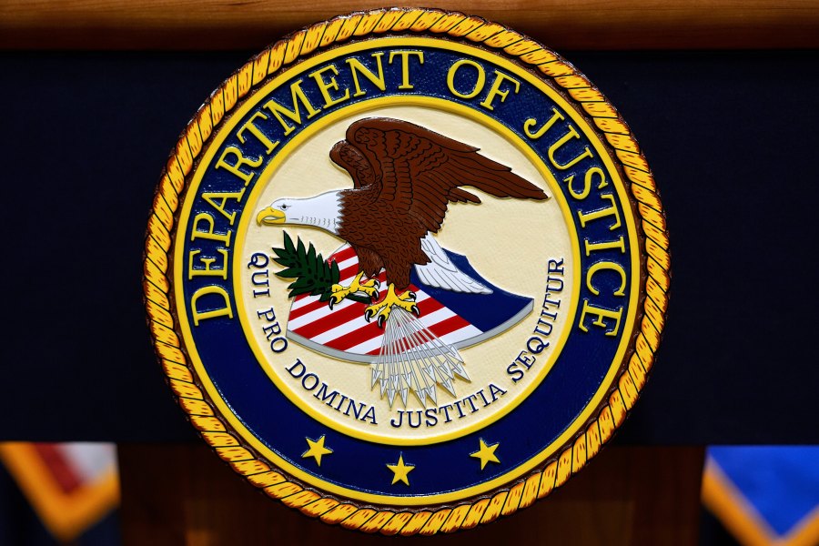 FILE - The U.S. Department of Justice logo is seen on a podium before a press conference with Attorney General Pam Bondi, May 6, 2025, at the Justice Department in Washington. (AP Photo/Julia Demaree Nikhinson, File)