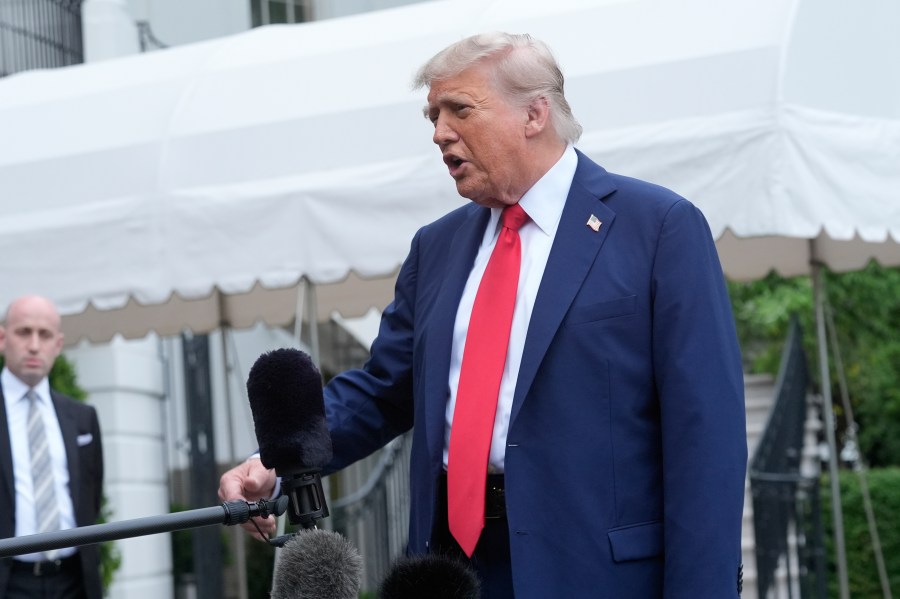 President Donald Trump speaks with reporters as White House Deputy Chief of Staff Stephen Miller listens before departing the White House on his way to attend the G7 Summit in Canada, Sunday, June 15, 2025, in Washington. (AP Photo/Manuel Balce Ceneta)