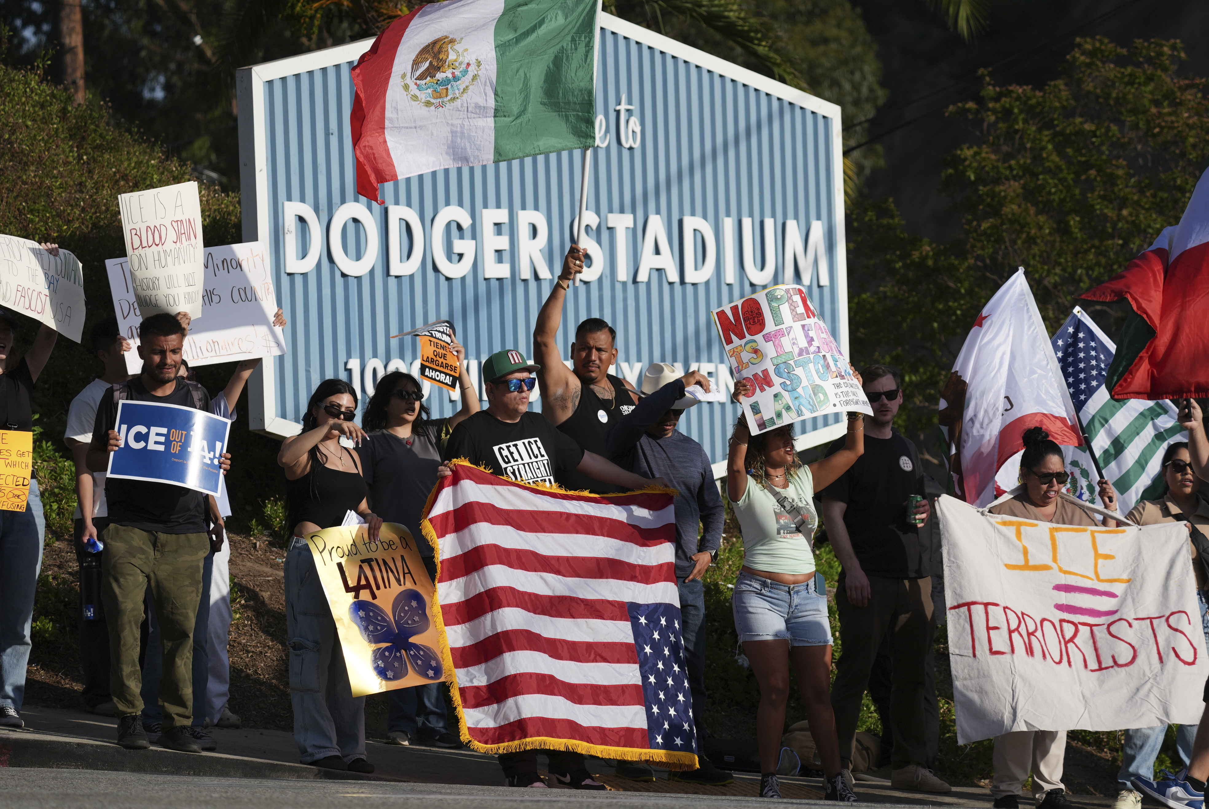 FILE - Demonstrators stage outside Dodger Stadium, June 21, 2025, in Los Angeles. (AP Photo/Damian Dovarganes, file)