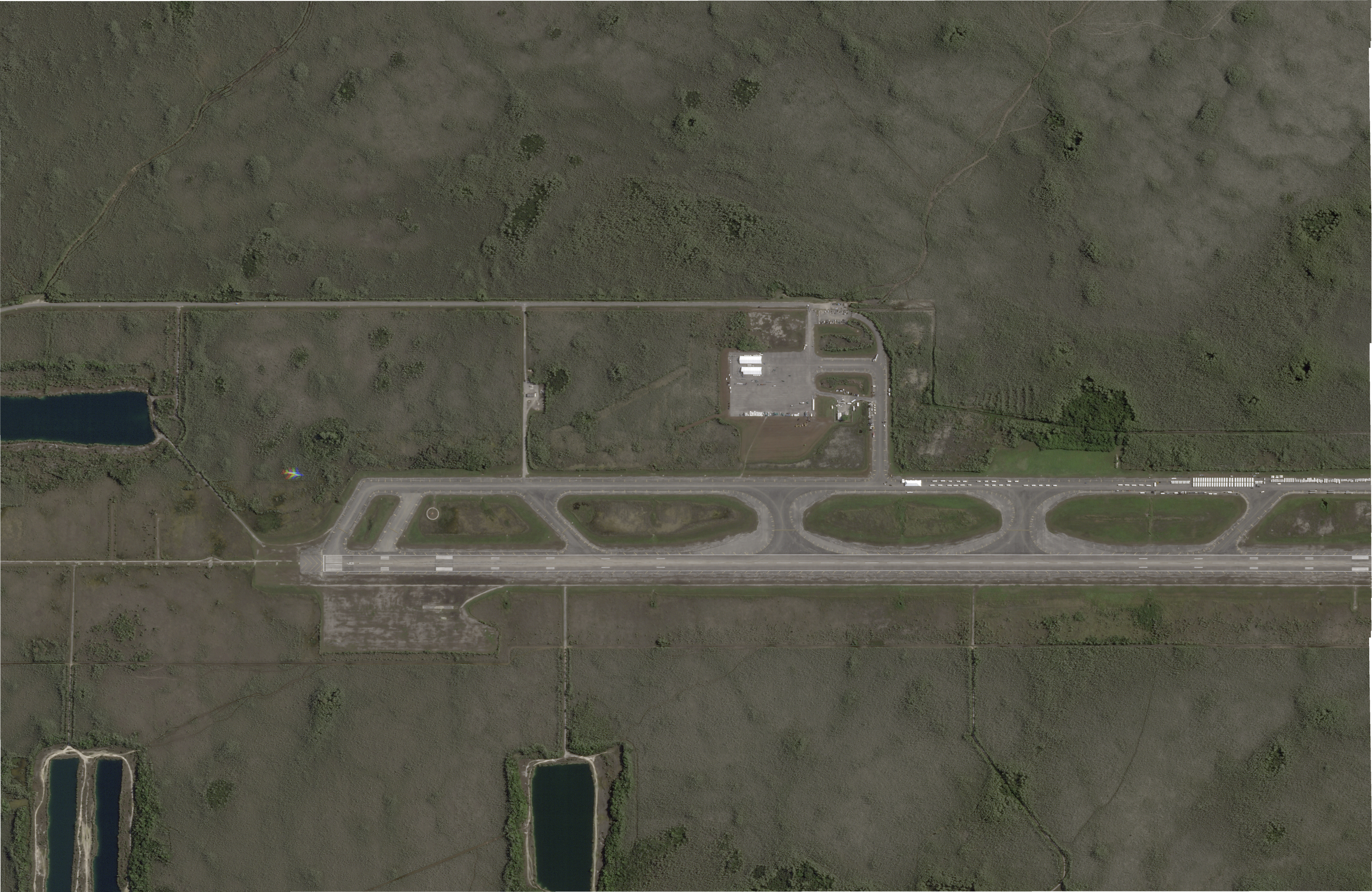 This satellite photo captured by Planet Labs PBC on June 25, 2025, shows white structures cropping up on an airstrip in Ochopee, Fla., in the Everglades, where state officials are building an immigration detention facility. (Planet Labs PBC via AP)