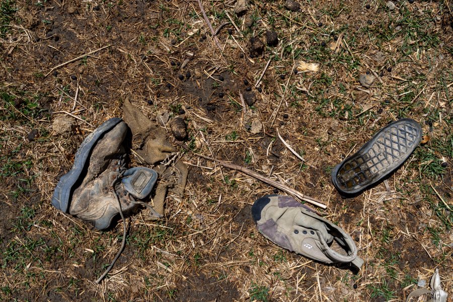 Worn out shoes are strewn in a field in the abandoned Samjung village, Mustang region, 462 kilometers (288 miles) west of Kathmandu, Nepal, Friday, April 18, 2025. (AP Photo/Niranjan Shrestha)