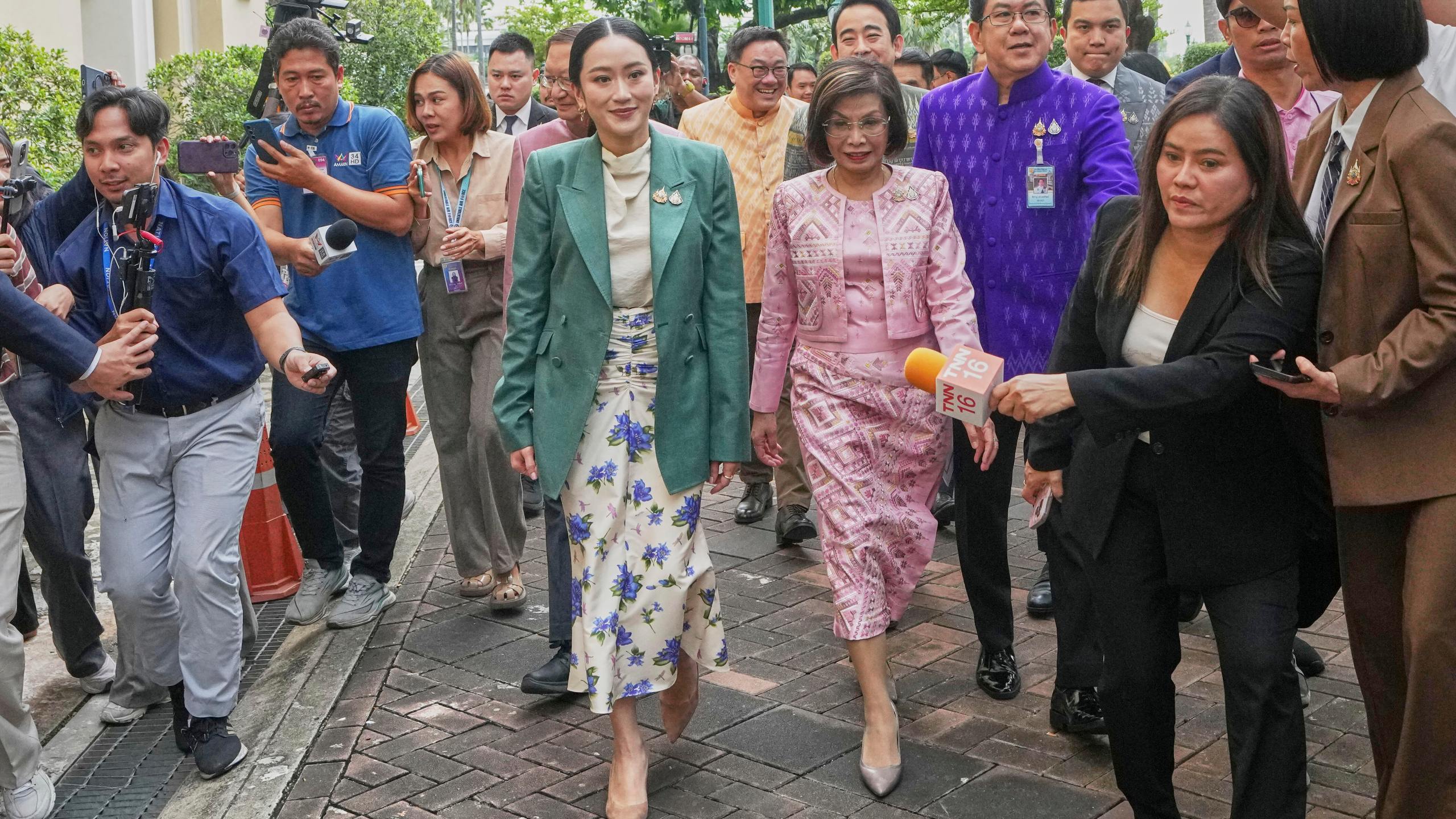 Thailand's Prime Minister Paetongtarn Shinawatra, center, arrives at Government House for a cabinet meeting in Bangkok, Thailand, Tuesday, July 1, 2025. (AP Photo/Sakchai Lalit)