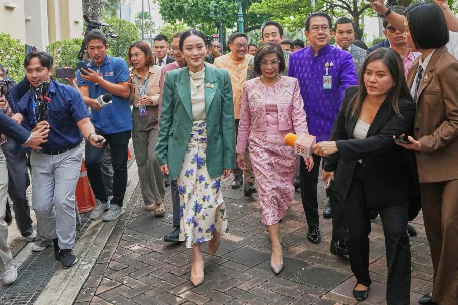 Thailand's Prime Minister Paetongtarn Shinawatra, center, arrives at Government House for a cabinet meeting in Bangkok, Thailand, Tuesday, July 1, 2025. (AP Photo/Sakchai Lalit)