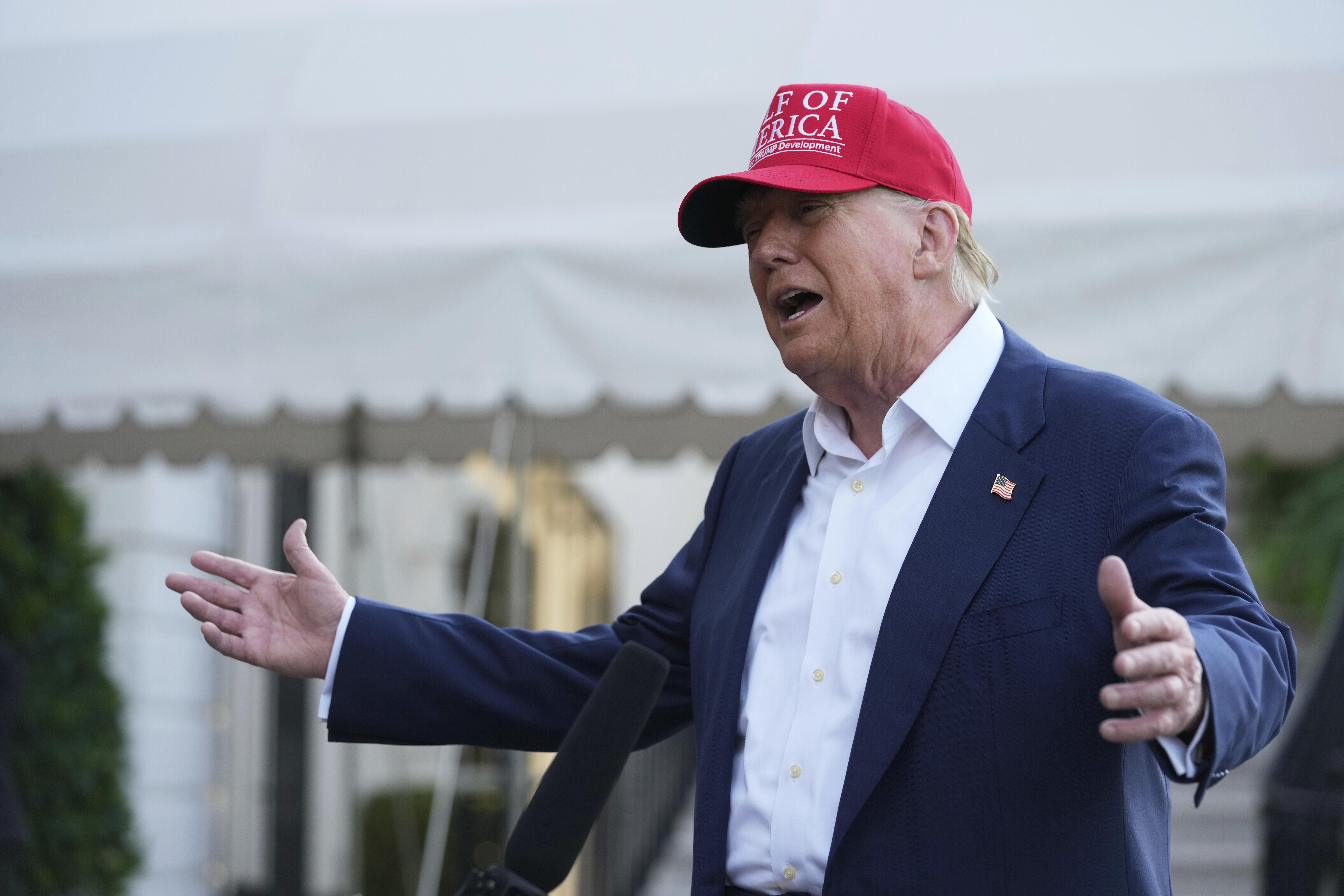 President Donald Trump speaks to the media before walking across the South Lawn of the White House to board Marine One en route to Joint Base Andrews, Md., and on to Florida, Tuesday, July 1, 2025, in Washington. (AP Photo/Mark Schiefelbein)