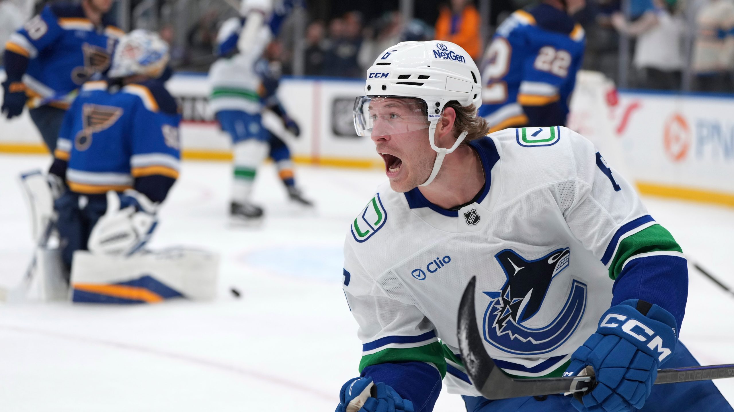 FILE - Vancouver Canucks' Brock Boeser, right, celebrates after scoring past St. Louis Blues goaltender Jordan Binnington, left, during the third period of an NHL hockey game, March 20, 2025, in St. Louis. (AP Photo/Jeff Roberson, file)