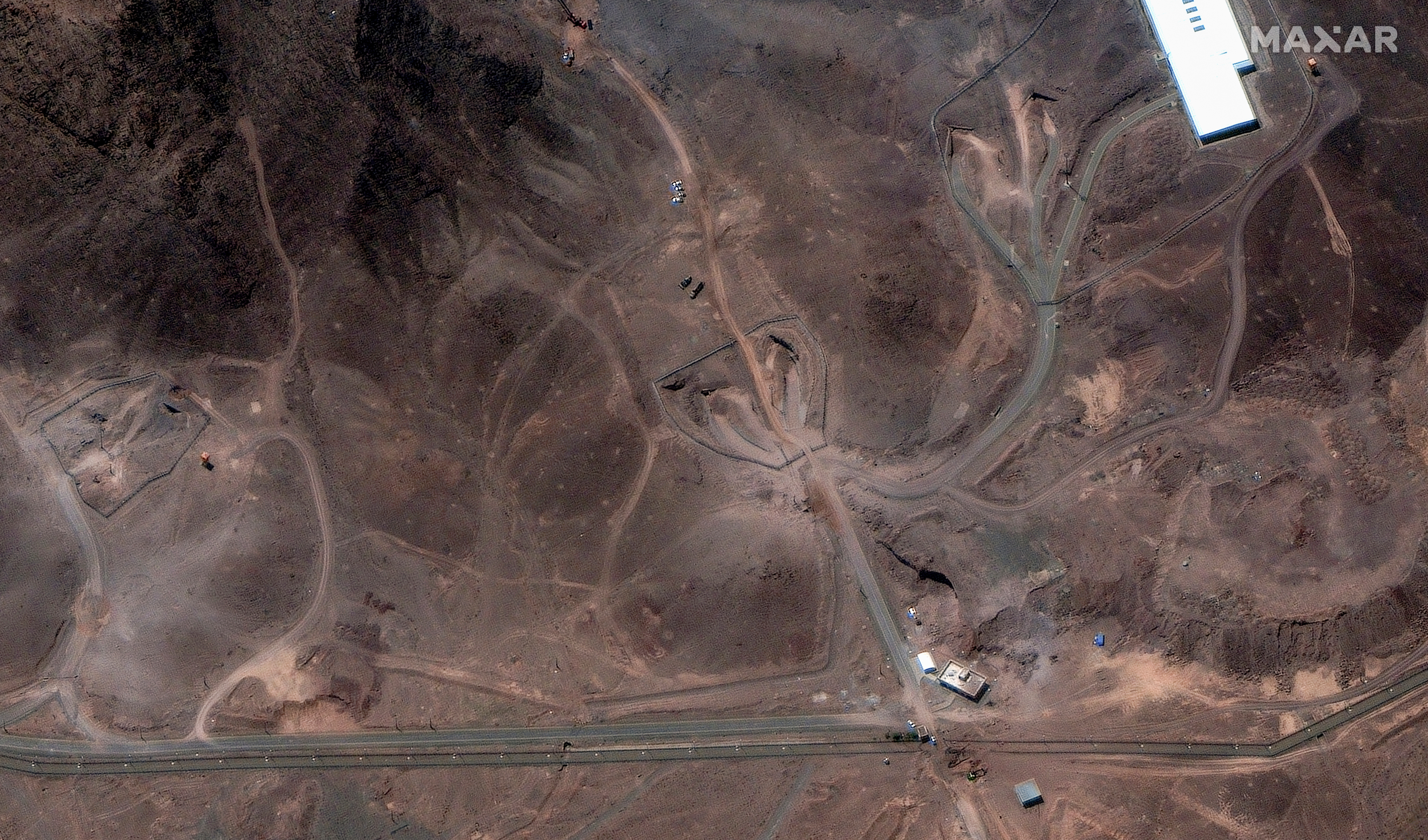 This satellite image provided by Maxar Technologies shows tunnel entrances to Fordo enrichment facility in Iran, on June 29, 2025. (Maxar Technologies via AP)