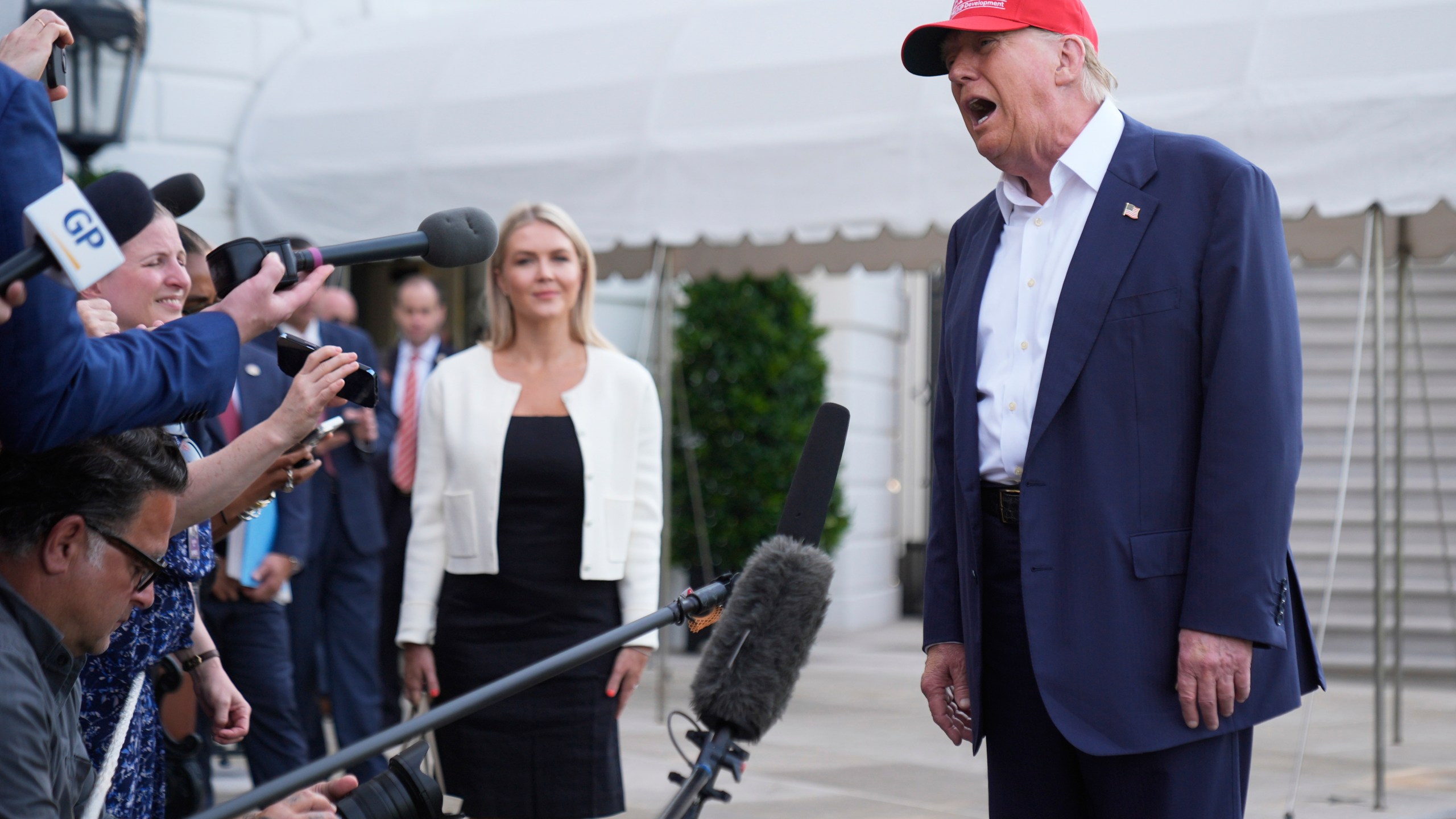 President Donald Trump speaks to the media before walking across the South Lawn of the White House to board Marine One en route to Joint Base Andrews, Md., and on to Florida, Tuesday, July 1, 2025, in Washington. (AP Photo/Mark Schiefelbein)