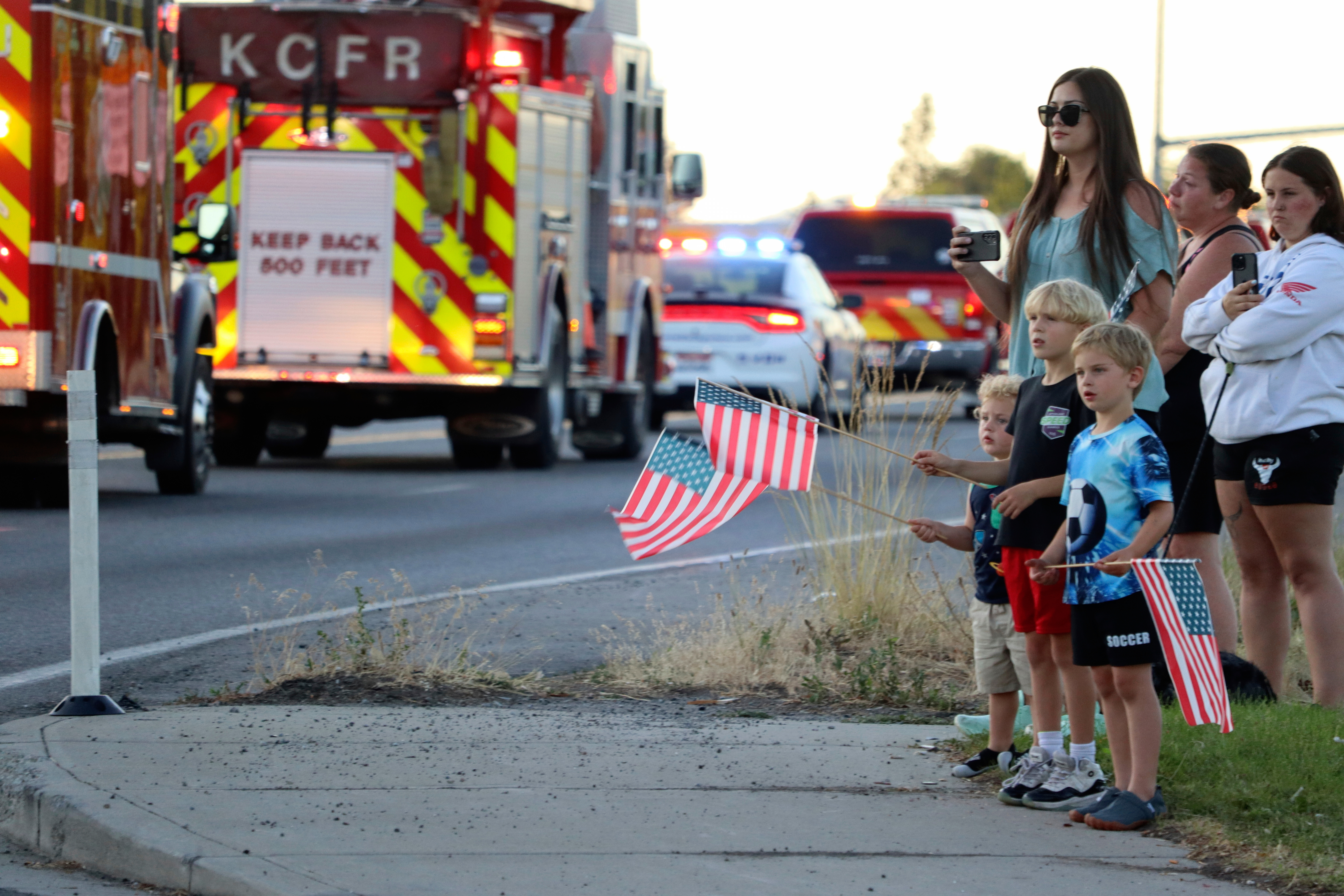 A procession from Kootenai Health heads to the medical examiner's office in Spokane, Wash., after firefighters were killed Sunday, June 29, 2025, when they were ambushed by sniper fire while responding to a blaze near Coeur d’Alene, Idaho. (Bill Buley/Coeur D'Alene Press via AP)