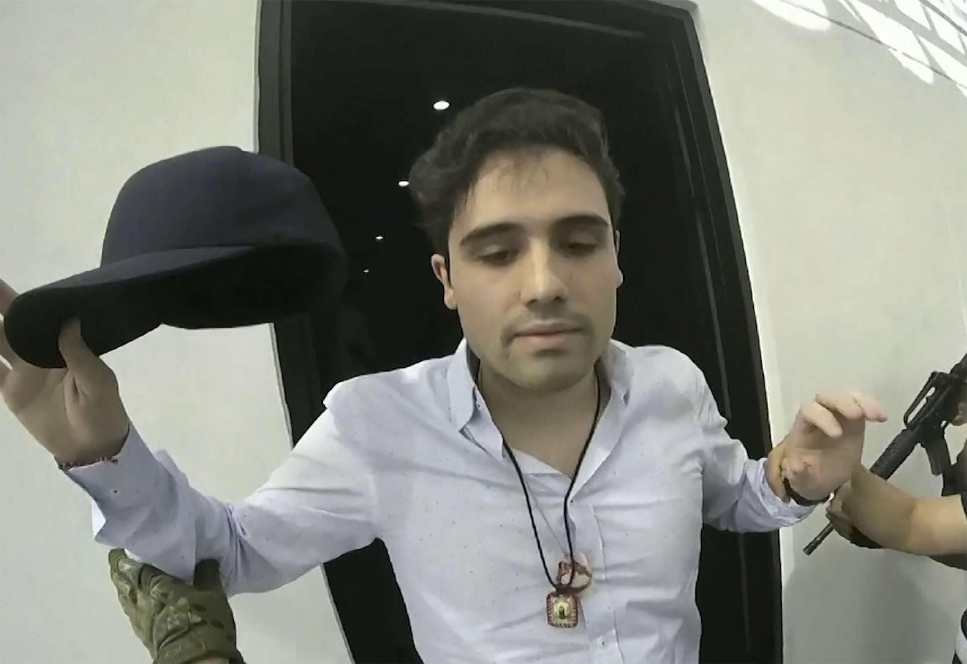 FILE - This frame grab from video, provided by the Mexican government, shows Ovidio Guzman Lopez being detained in Culiacan, Mexico, Oct. 17, 2019. (CEPROPIE via AP File)