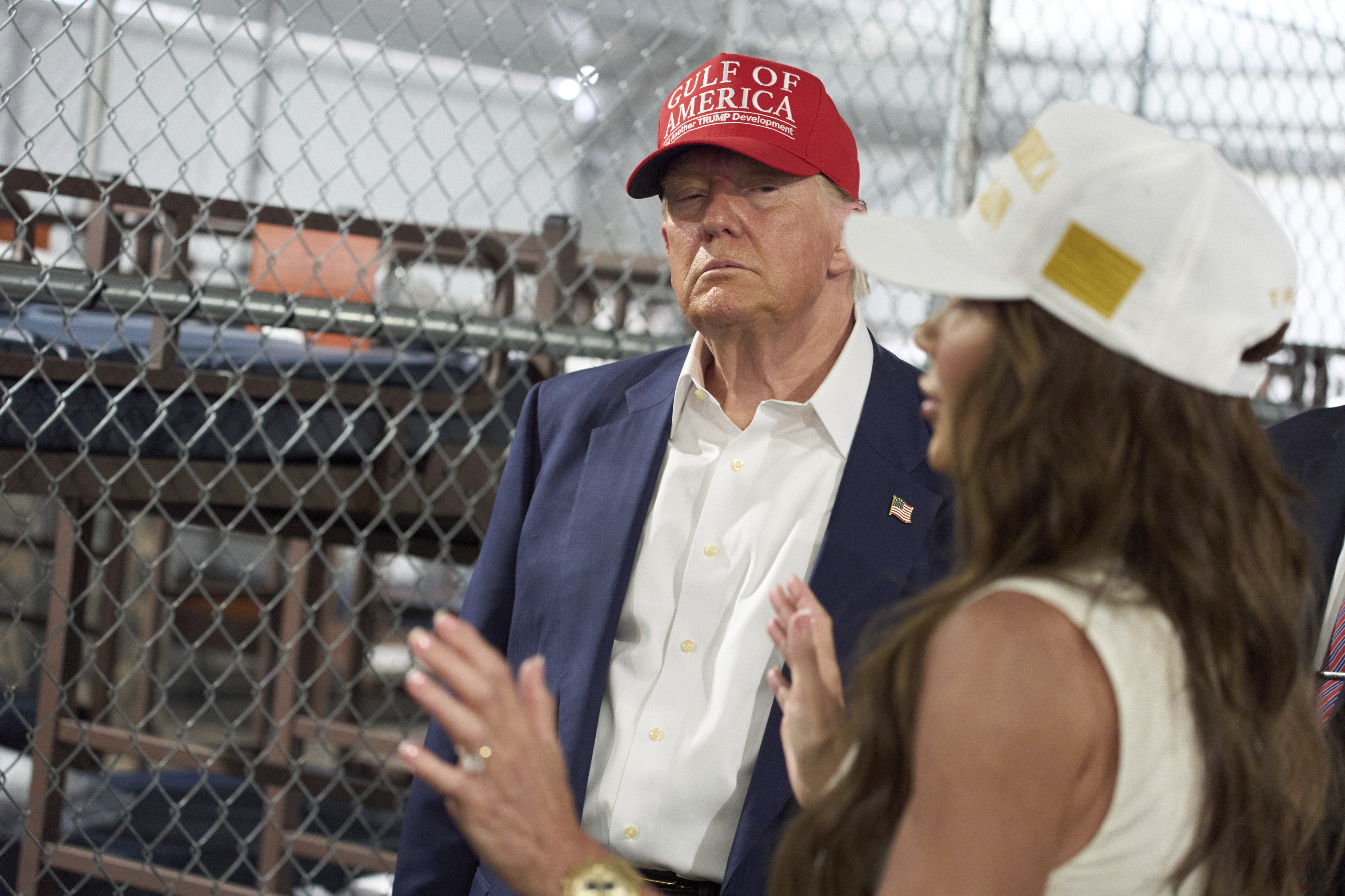 President Donald Trump listens as Homeland Security Secretary Kristi Noem speaks during a tour of "Alligator Alcatraz," a new migrant detention facility at Dade-Collier Training and Transition facility, Tuesday, July 1, 2025, in Ochopee, Fla. (AP Photo/Evan Vucci)