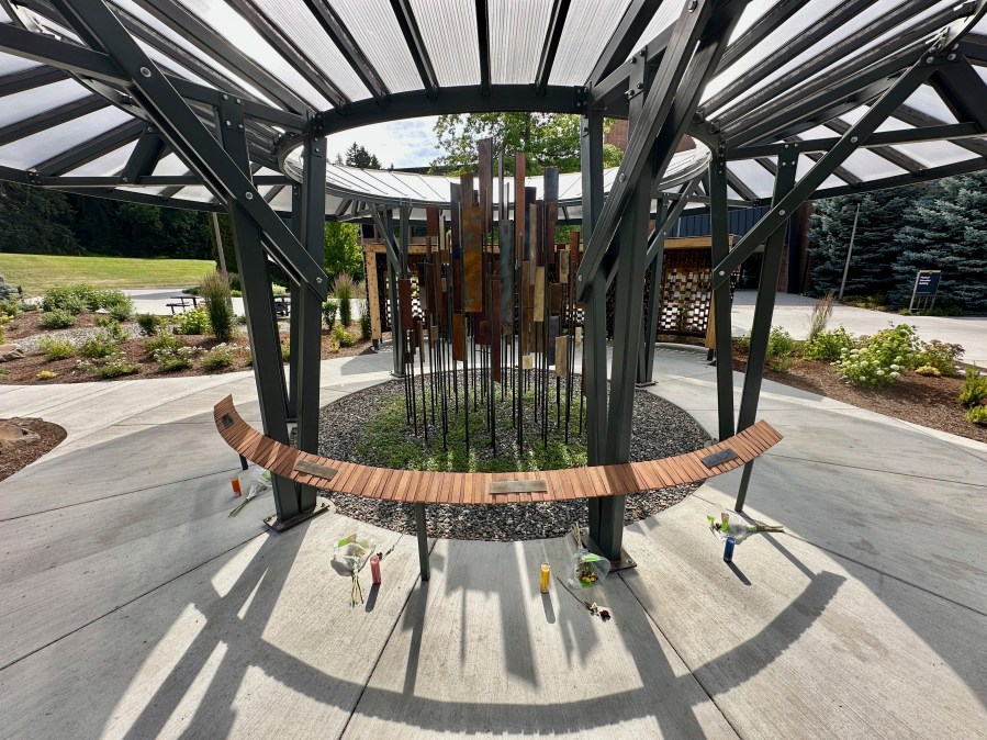 During their memorial, flowers and candles are seen below the names of the University of Idaho students who were killed in November 2022 at their off campus house in Moscow, Idaho, Tuesday, July 1, 2025. (AP Photo/Manuel Valdes)