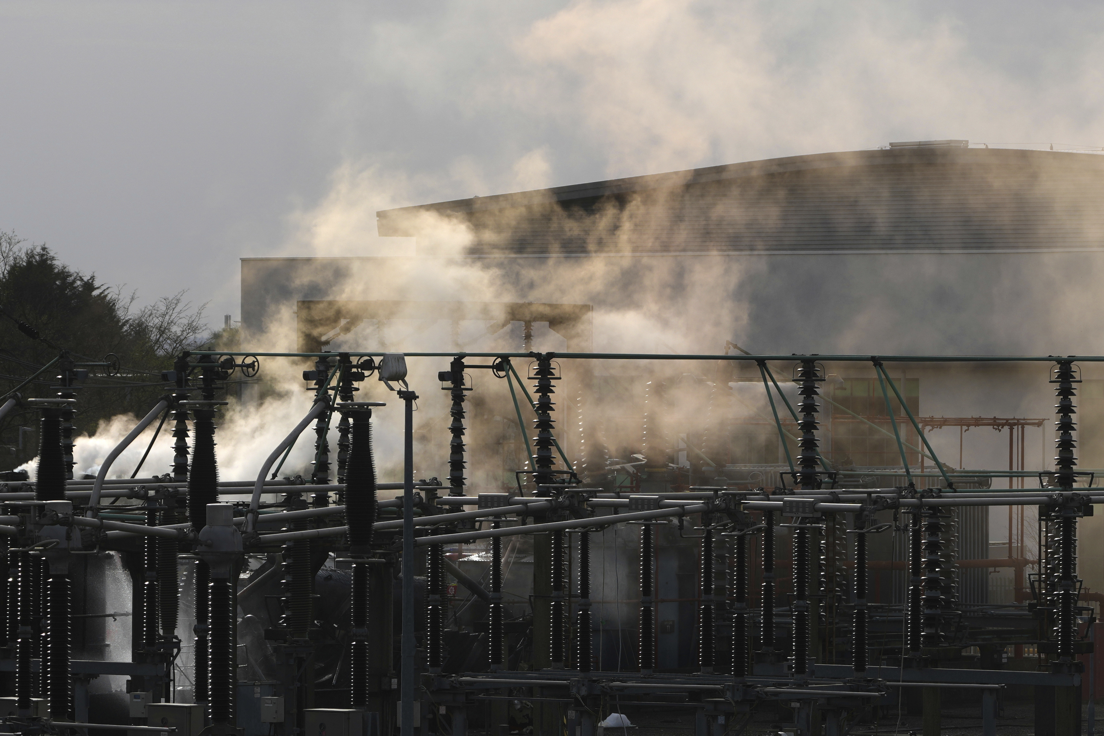 FILE -Smoke rises from the North Hyde electrical substation, which caught fire last night, leading to the closure of the Heathrow Airport, in London, March 21, 2025.(AP Photo/Kirsty Wigglesworth), File)