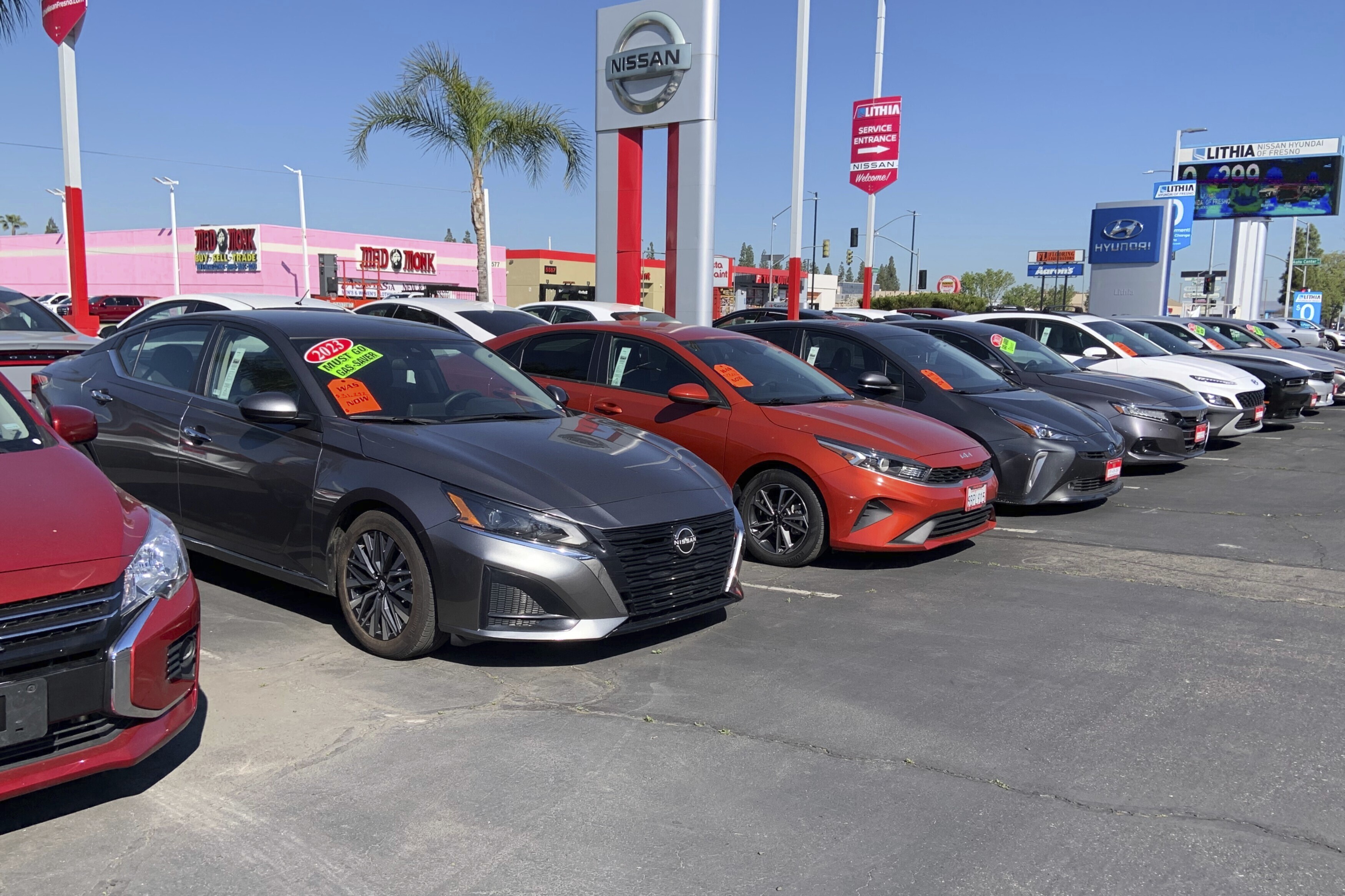 This photo provided by Edmunds shows a lineup of used cars at a Nissan dealership in Fresno, Calif. Used car prices are rising, but being open to alternatives to your ideal car may help uncover better value. (Courtesy of Edmunds via AP)