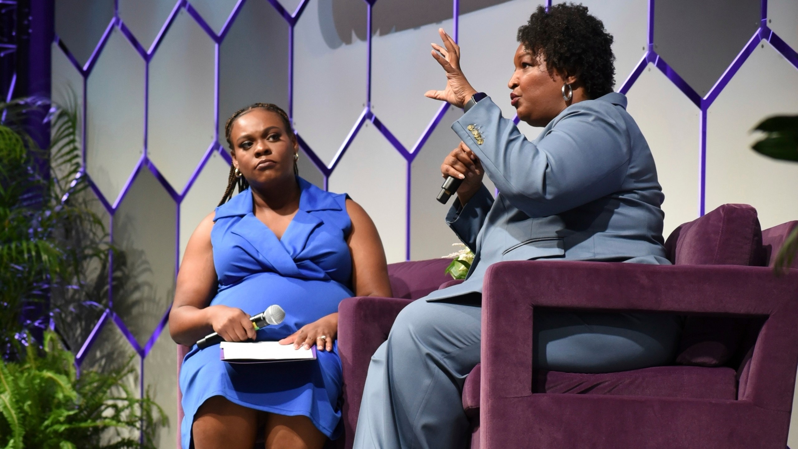 Two-time Georgia gubernatorial candidate and voting rights activist Stacey Abrams, right, sits next to Arekia Bennett-Scott, the executive director of Mississippi Votes, at the 2025 Democracy in Action Convening in Jackson, Miss., Saturday, June 28, 2025. (AP Photo/Sophie Bates)