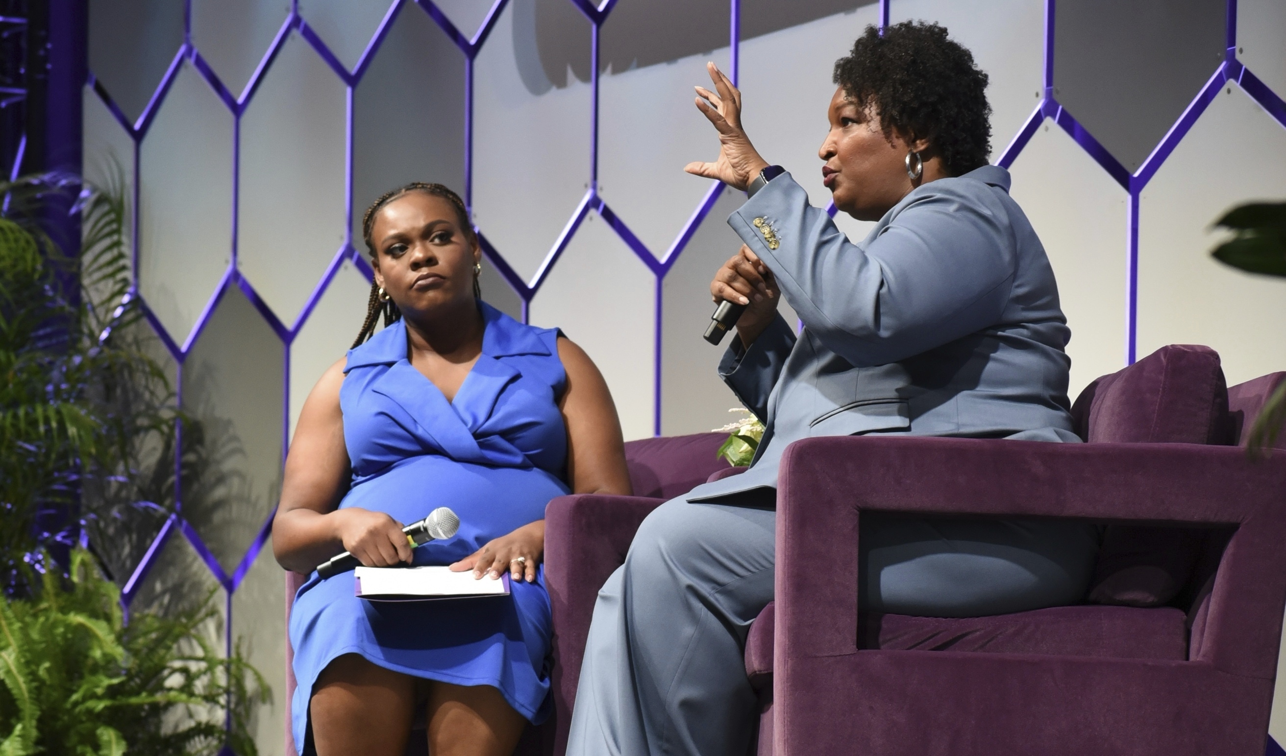 Two-time Georgia gubernatorial candidate and voting rights activist Stacey Abrams, right, sits next to Arekia Bennett-Scott, the executive director of Mississippi Votes, at the 2025 Democracy in Action Convening in Jackson, Miss., Saturday, June 28, 2025. (AP Photo/Sophie Bates)