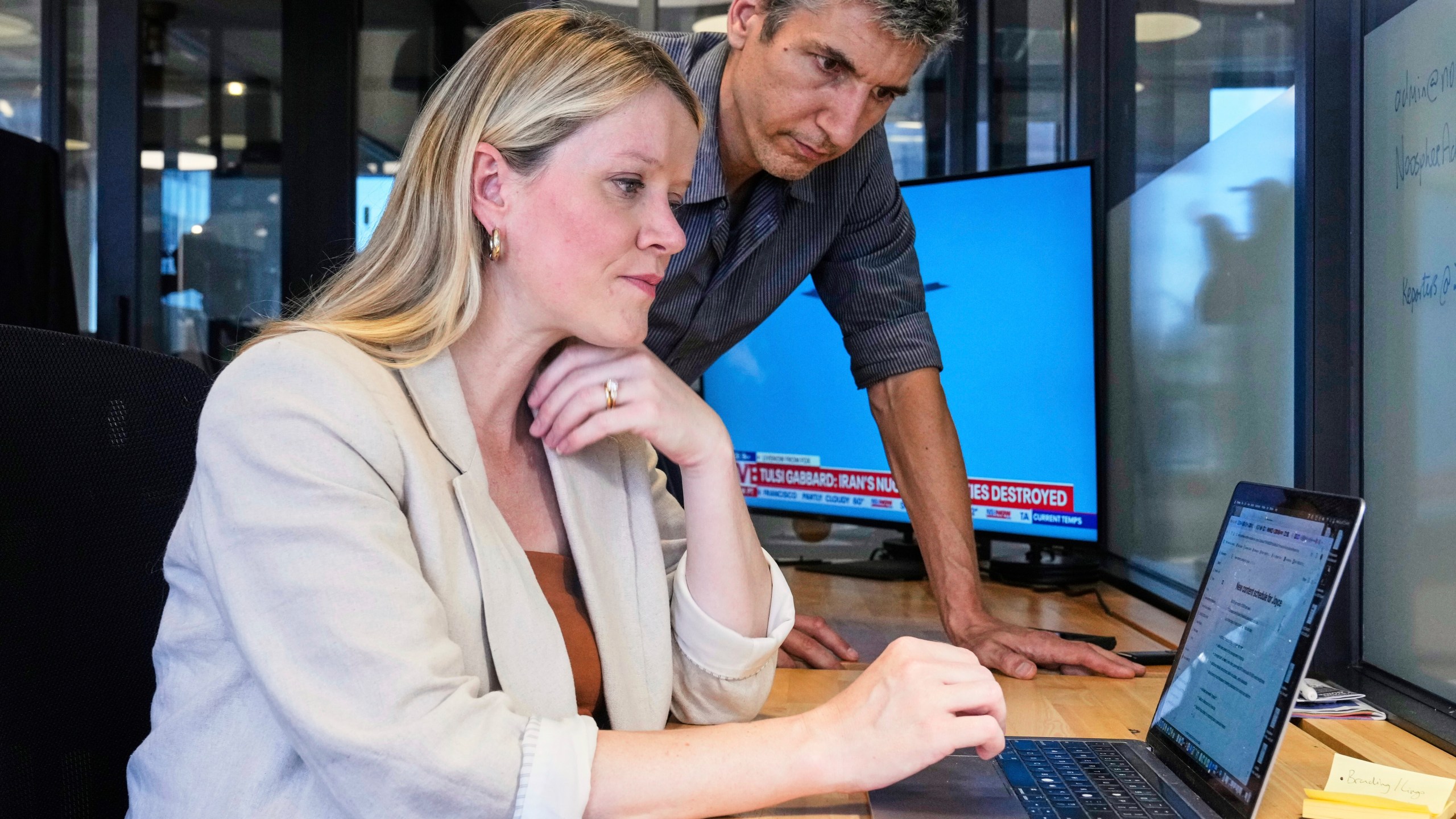 Jane Ferguson, founder of Noosphere, and Sebastian Walker, head of content, are photographed in the site's office, in New York, Wednesday, June 25, 2025. (AP Photo/Richard Drew)