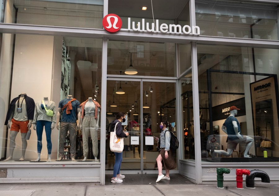 FILE - Lululemon fashions are displayed in company store windows, March 25, 2021, in New York. (AP Photo/Mark Lennihan, File)