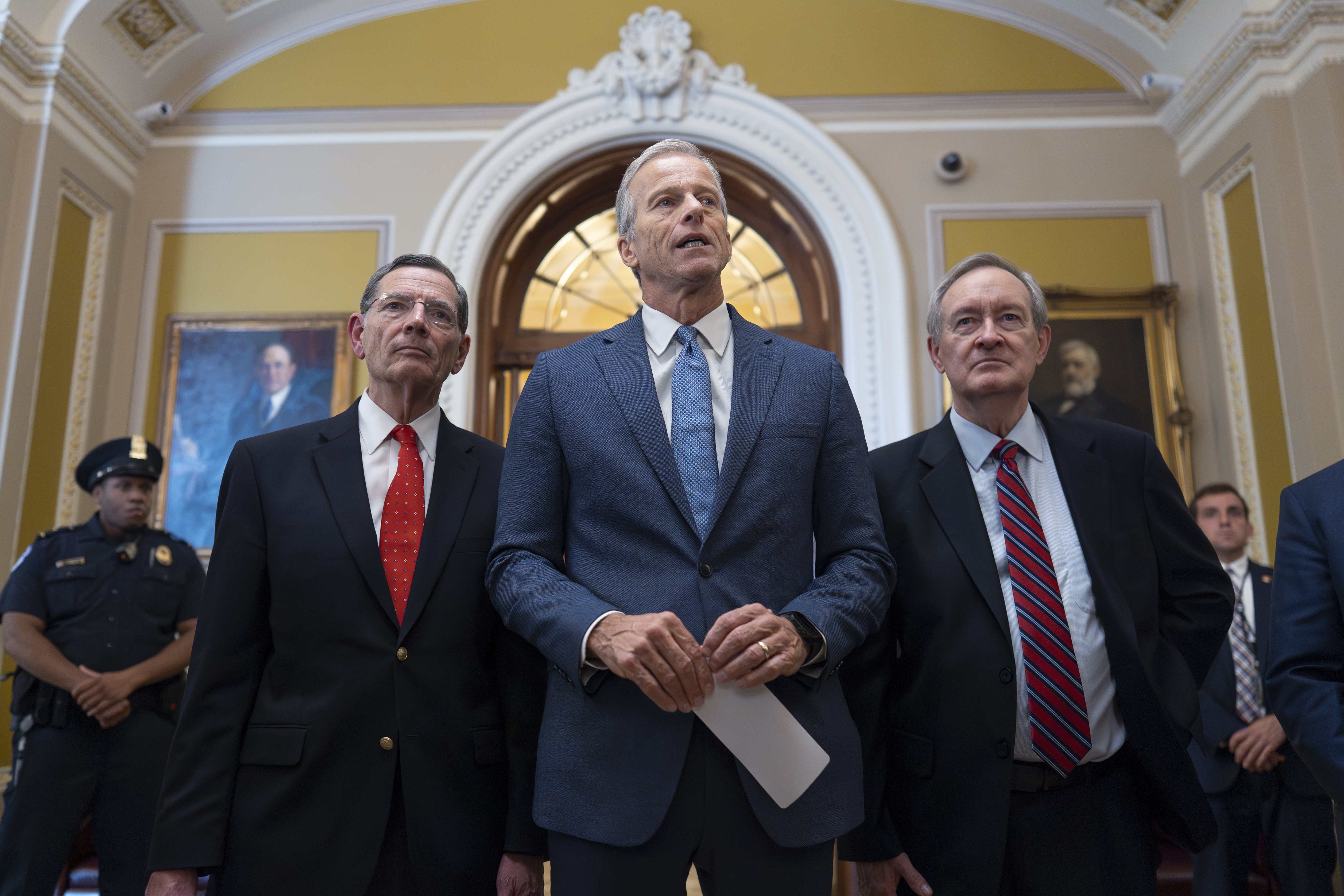 Senate Majority Leader John Thune, R-S.D., is flanked by Sen. John Barrasso, R-Wyo., the GOP whip, left, and Finance Committee Chairman Mike Crapo, R-Idaho, speaks to reporters after passage of the budget reconciliation package of President Donald Trump's signature bill of big tax breaks and spending cuts, at the Capitol in Washington, Tuesday, July 1, 2025. (AP Photo/J. Scott Applewhite)