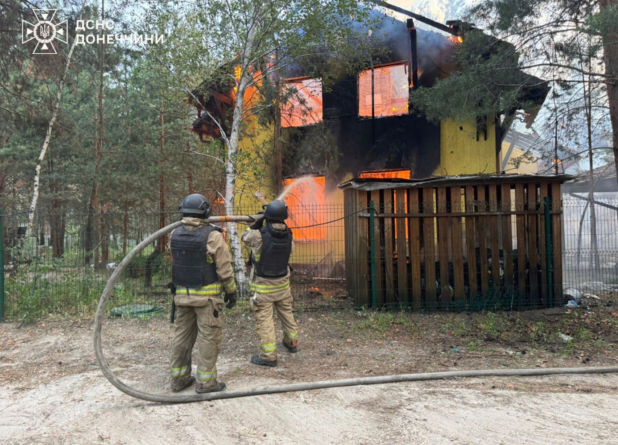 In this photo provided by the Ukrainian Emergency Service, emergency services personnel work to extinguish a fire following a Russian attack in Donetsk region, Ukraine, Wednesday, July 2, 2025. (Ukrainian Emergency Service via AP)