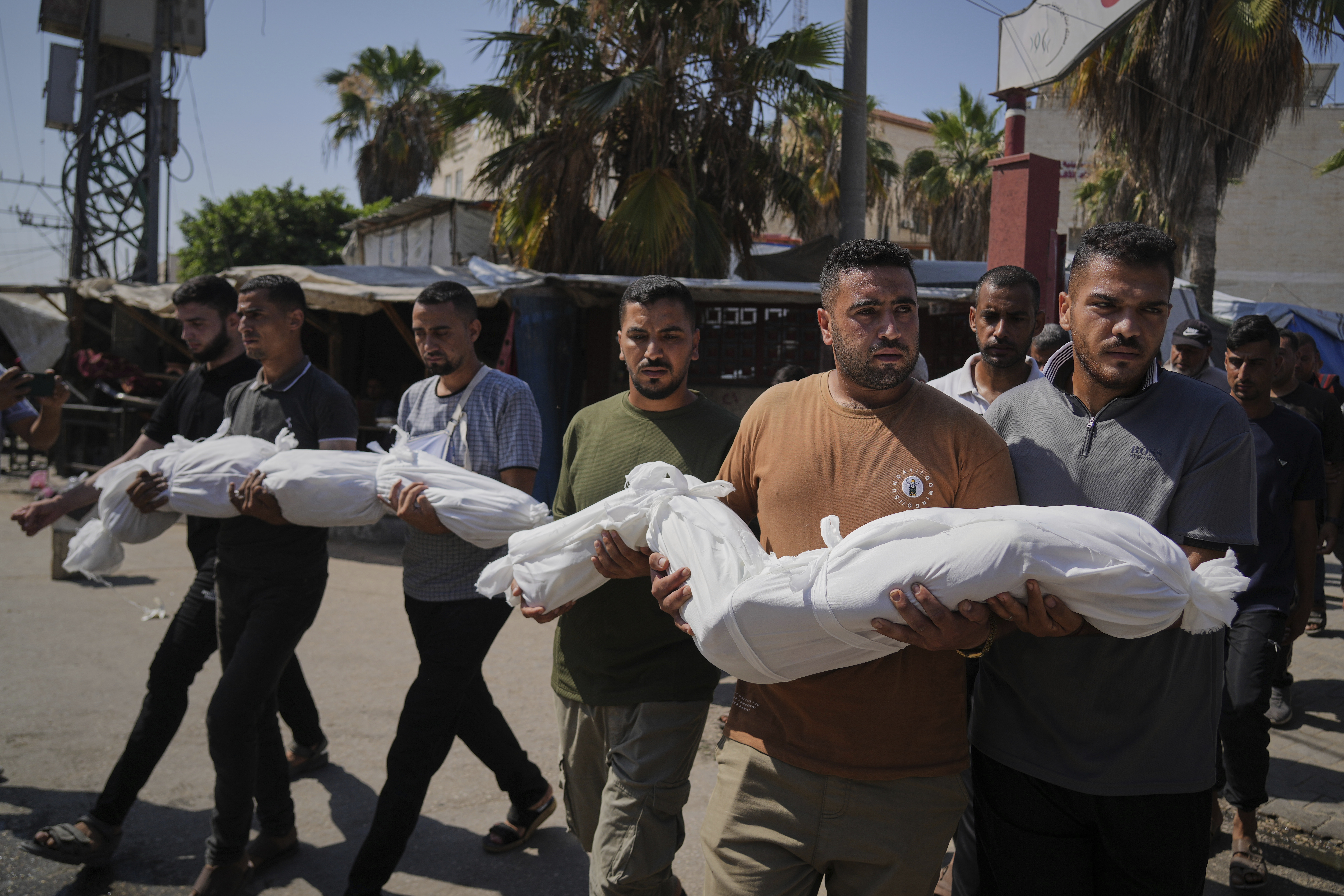 Relatives carry the bodies of two Palestinian sisters Mira, 8, and Sabah Bashir, 10, who were killed in an Israeli army airstrike of the Gaza Strip, during their funeral in Deir al-Balah, Wednesday, July 2, 2025. (AP Photo/Abdel Kareem Hana)