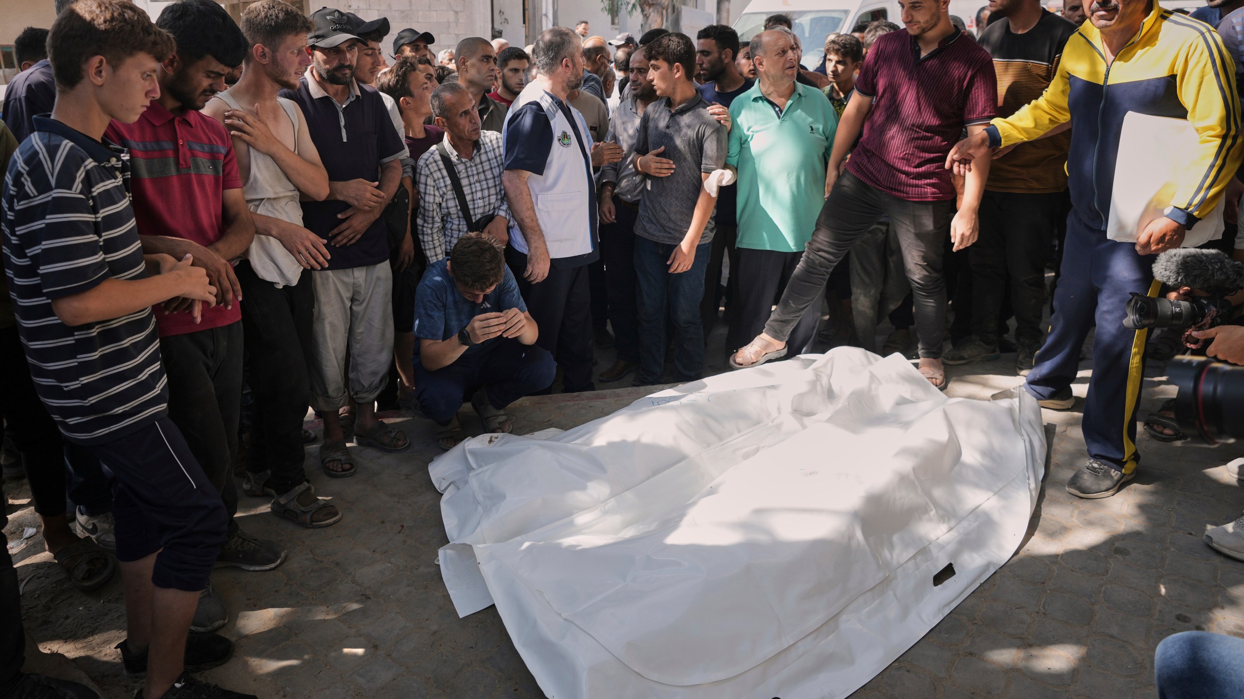 Palestinians gather around the bodies of Dr. Marwan Sultan the director of the Indonesian Hospital in the northern Gaza Strip, his wife, daughter, and son in law, after they were killed in an Israeli airstrike, at Shifa Hospital in Gaza City Wednesday, July 2, 2025. (AP Photo/Jehad Alshrafi)