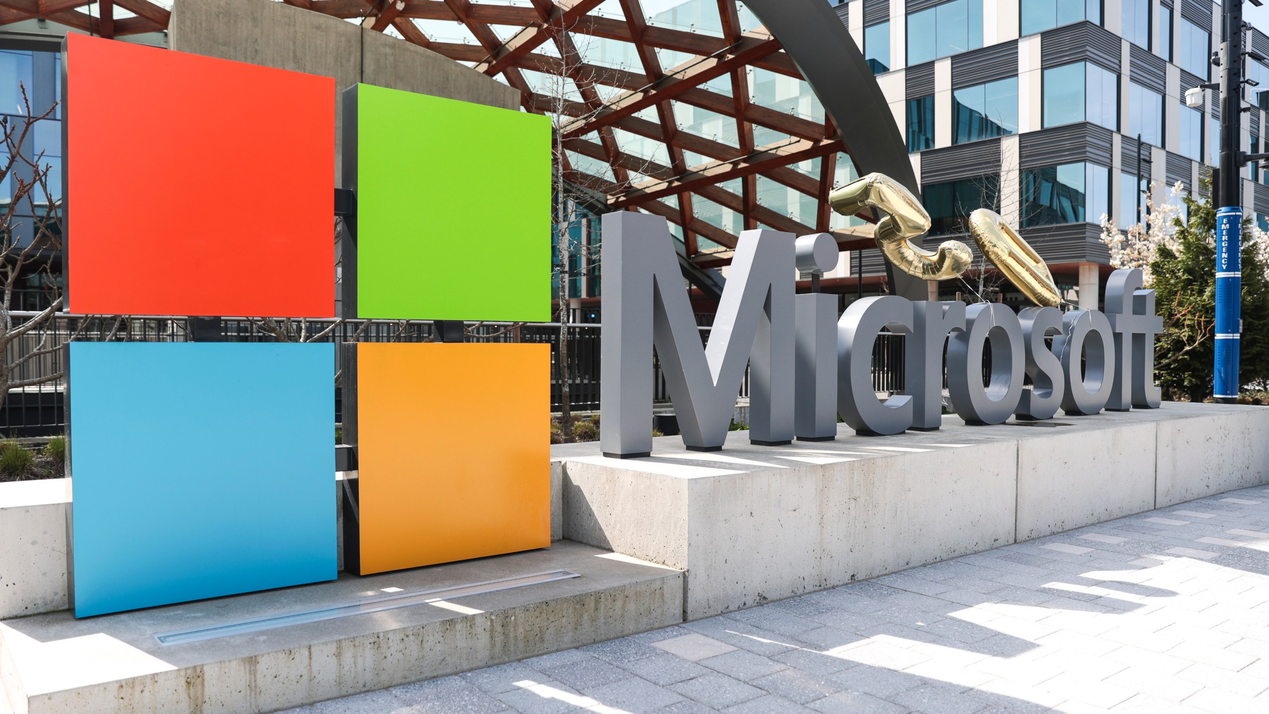 FILE - A Microsoft sign and logo are pictured at the company's headquarters, Friday, April 4, 2025, in Redmond, Wash. (AP Photo/Jason Redmond, File)
