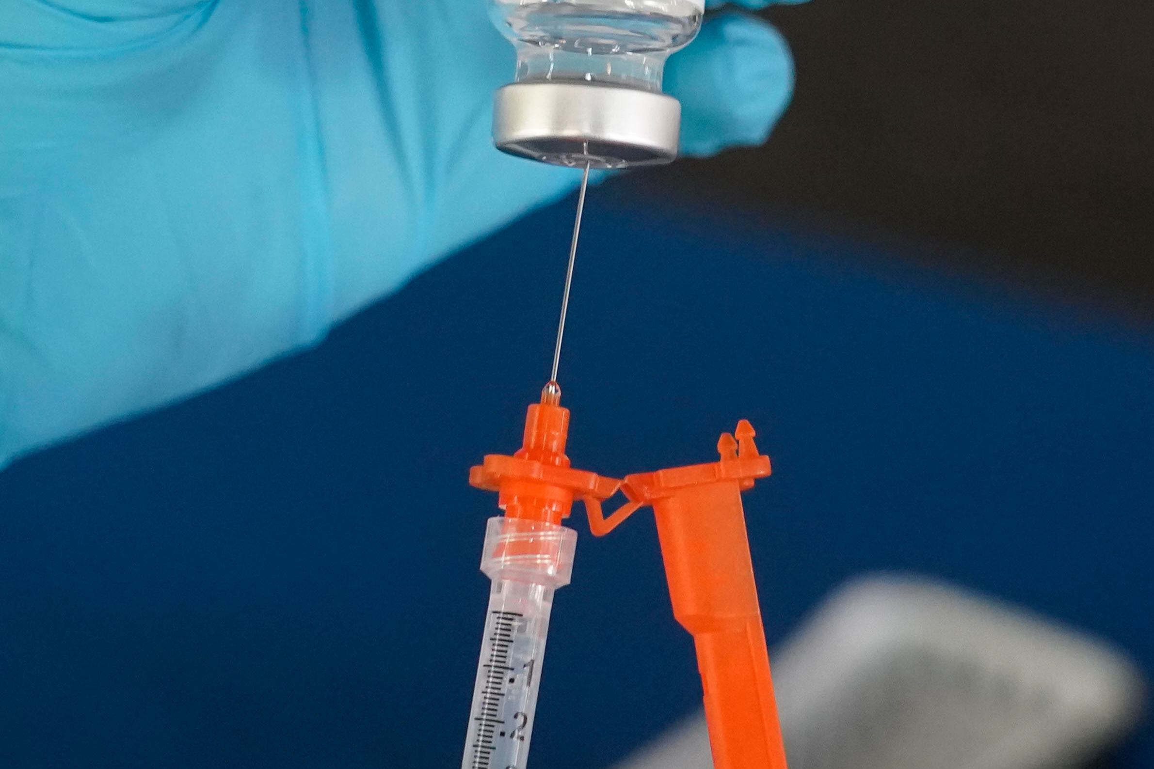 FILE - A nurse loads a syringe with a COVID-19 booster vaccine at an inoculation station in Jackson, Miss., Nov. 18, 2022. (AP Photo/Rogelio V. Solis, File)