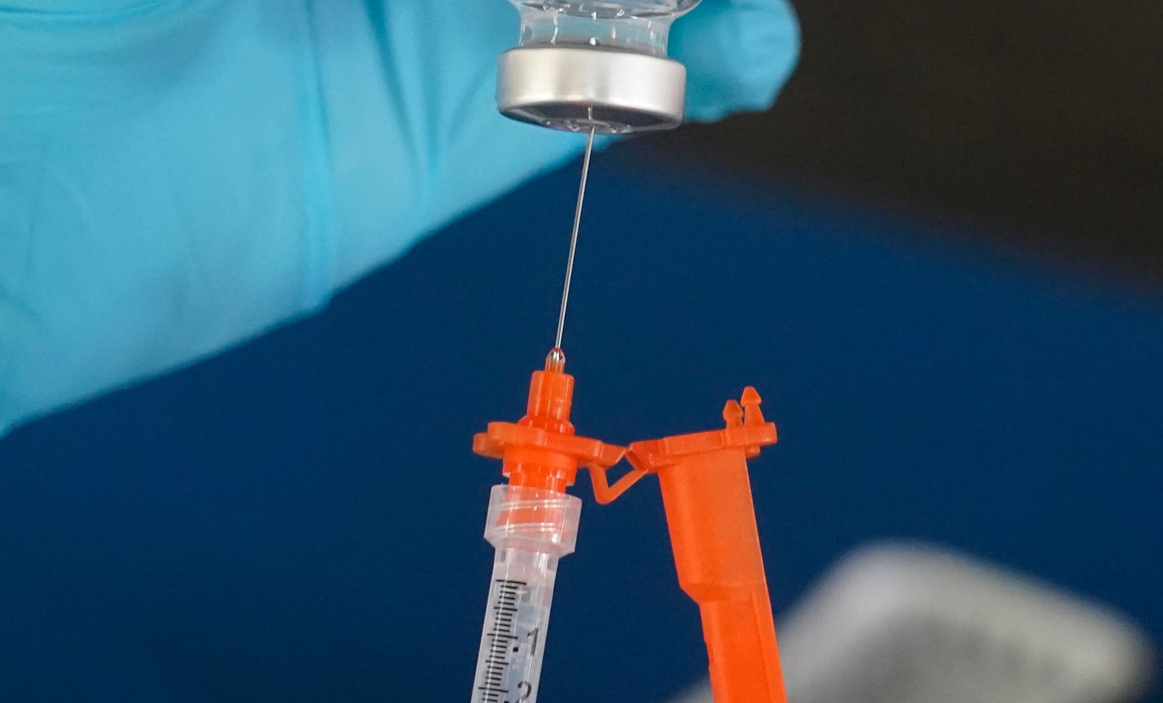 FILE - A nurse loads a syringe with a COVID-19 booster vaccine at an inoculation station in Jackson, Miss., Nov. 18, 2022. (AP Photo/Rogelio V. Solis, File)