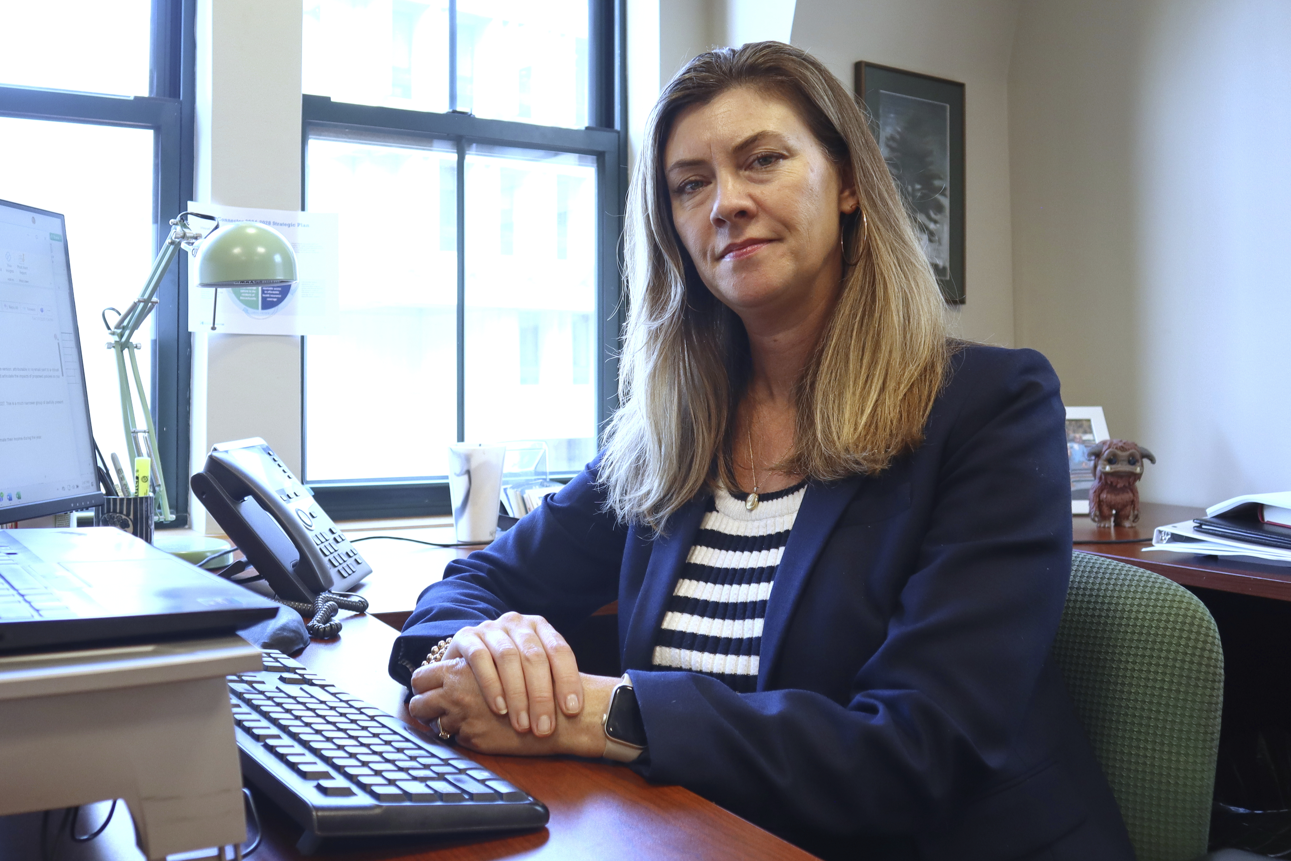Massachusetts Health Connector Executive Director Audrey Morse Gasteier poses for a portrait at her desk in the state health insurance marketplace's office Tuesday, July 2, 2025, in Boston. (AP Photo /Leah Willingham)