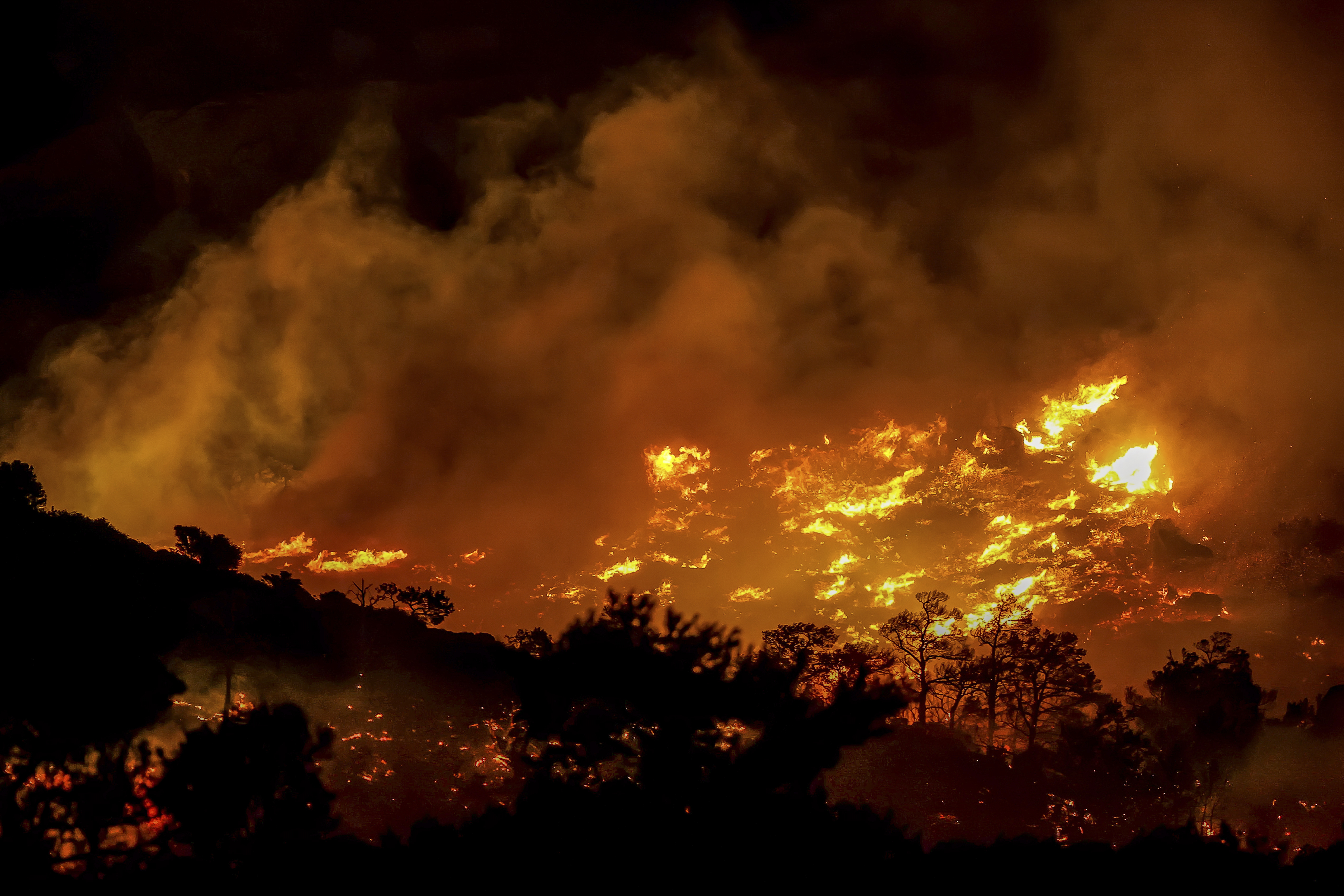Fire burns in the Ahlia area near the port town of Ierapetra on the south coast of Crete island, Greece, late Wednesday, July 2, 2025, prompting the evacuation of villages and hotels in the region, authorities said. (InTime News via AP)