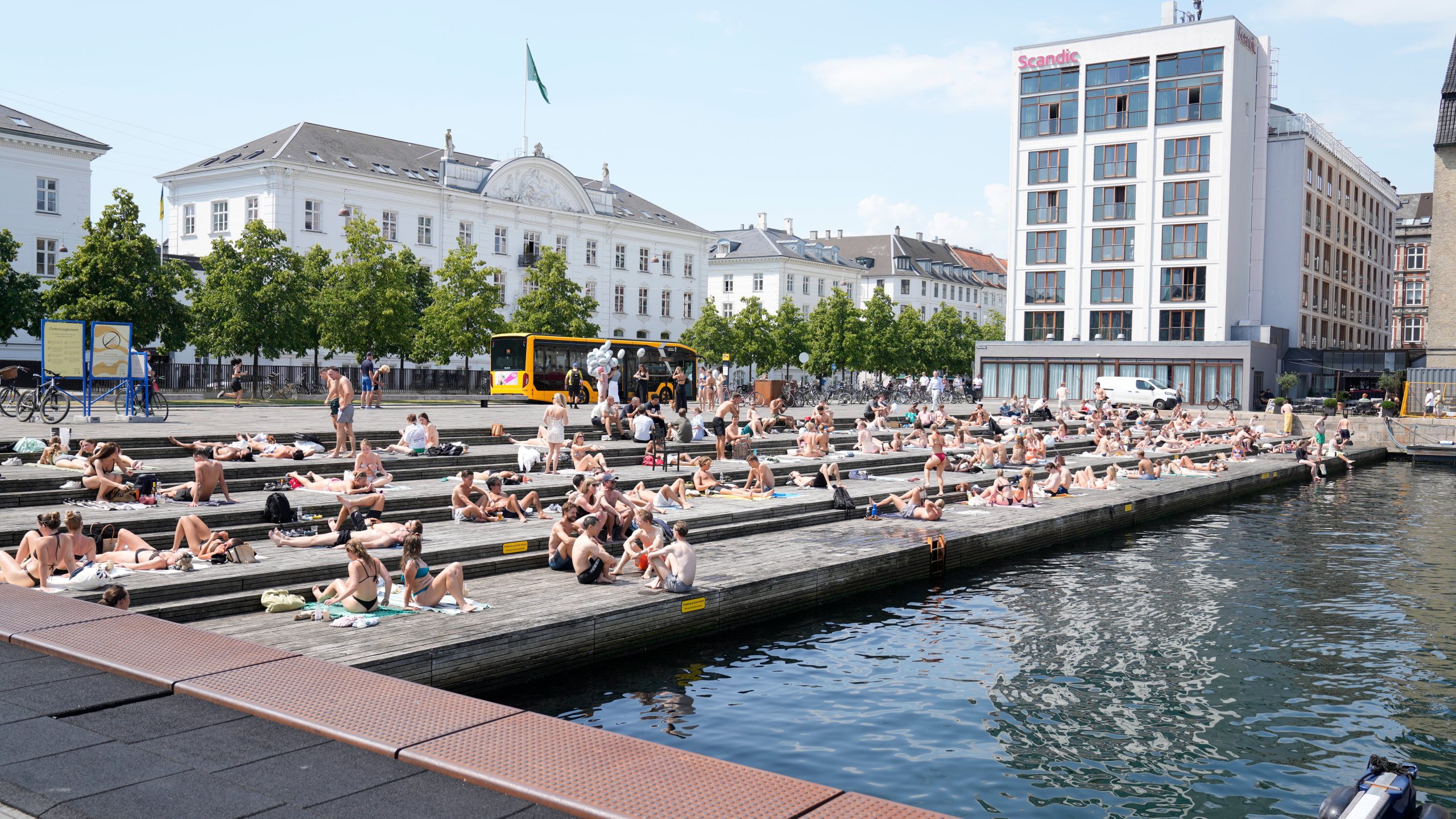 People relax at the the harbour bath at Ofelia Square in Copenhagen, Denmark, Wednesday July 2, 2025. (Thomas Traasdahl/Ritzau Scanpix via AP)