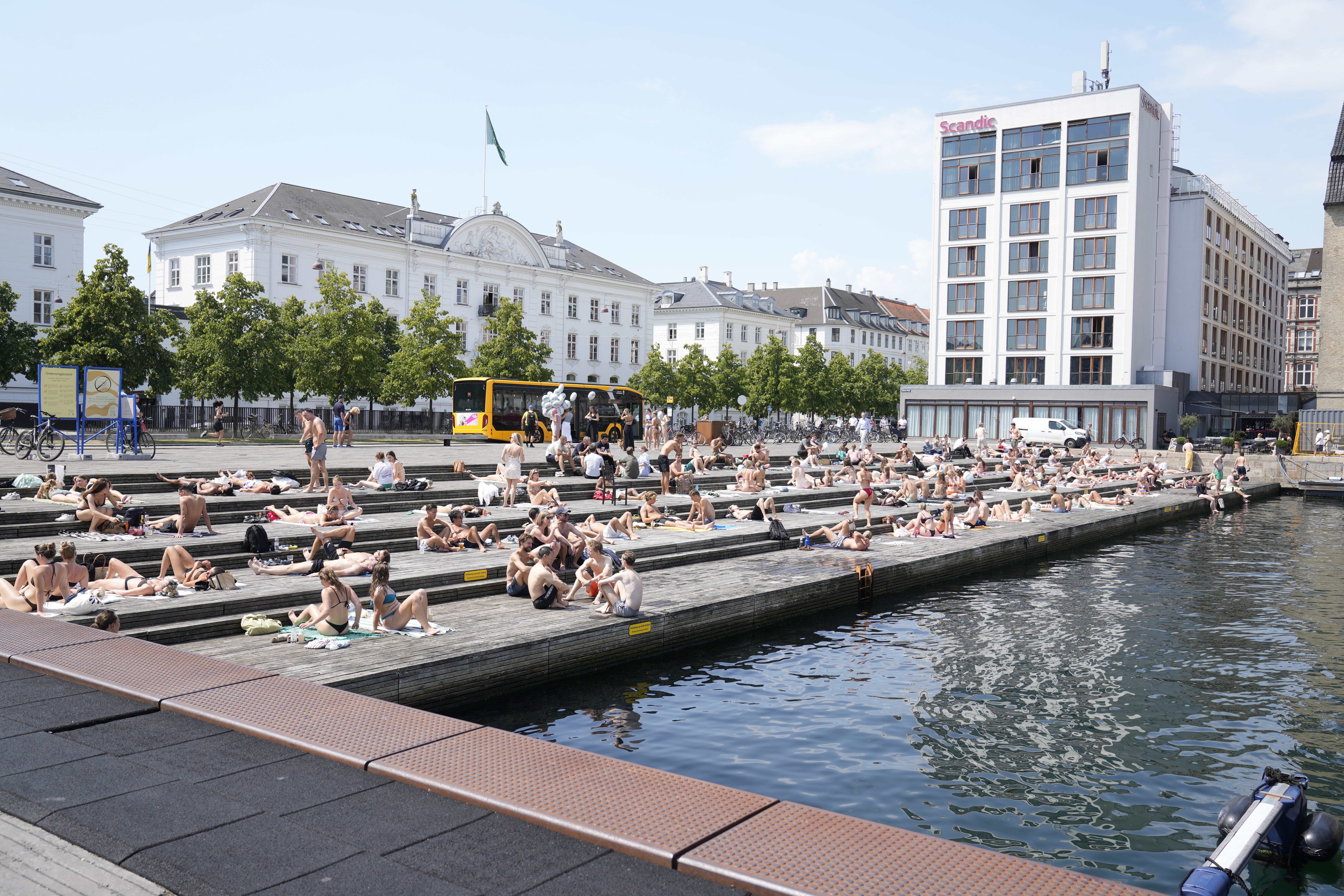 People relax at the the harbour bath at Ofelia Square in Copenhagen, Denmark, Wednesday July 2, 2025. (Thomas Traasdahl/Ritzau Scanpix via AP)