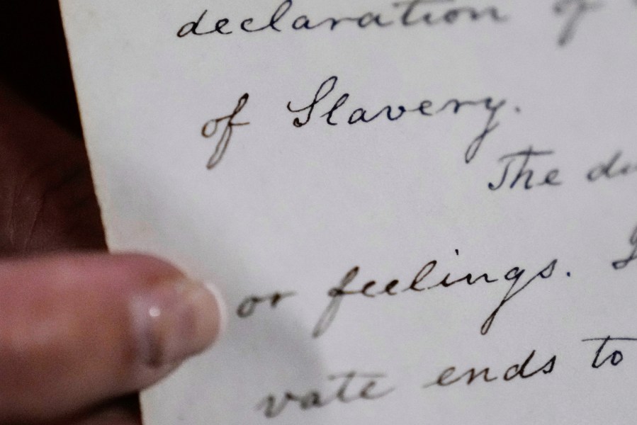 Historian Jennifer Cromack points out the word "Slavery" on a recently found, 178-year-old anti-slavery scroll at Grotonwood, the home mission of The American Baptist Churches of Massachusetts, Thursday, June 26, 2025, in Groton, Mass. (AP Photo/Charles Krupa)