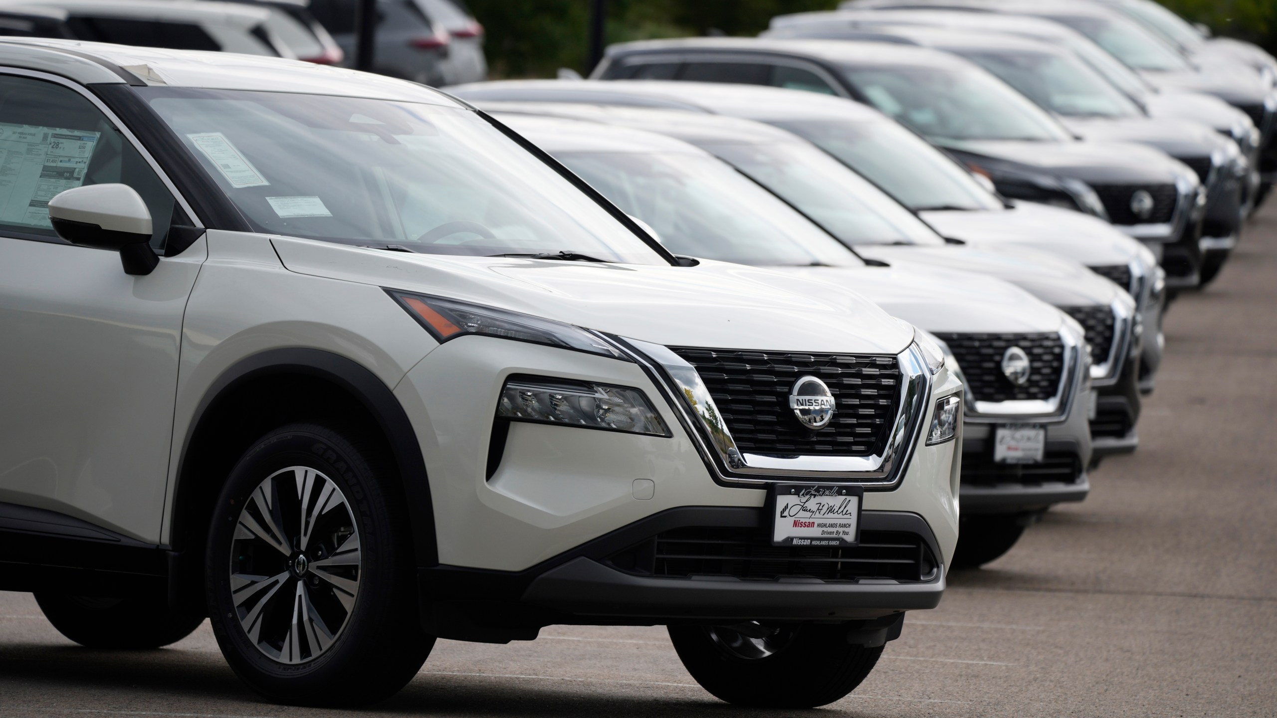 FILE - Unsold 2021 Rogue sports-utility vehicles sit on a lot at a Nissan dealership Colorado on June 27, 2021. (AP Photo/David Zalubowski, File)