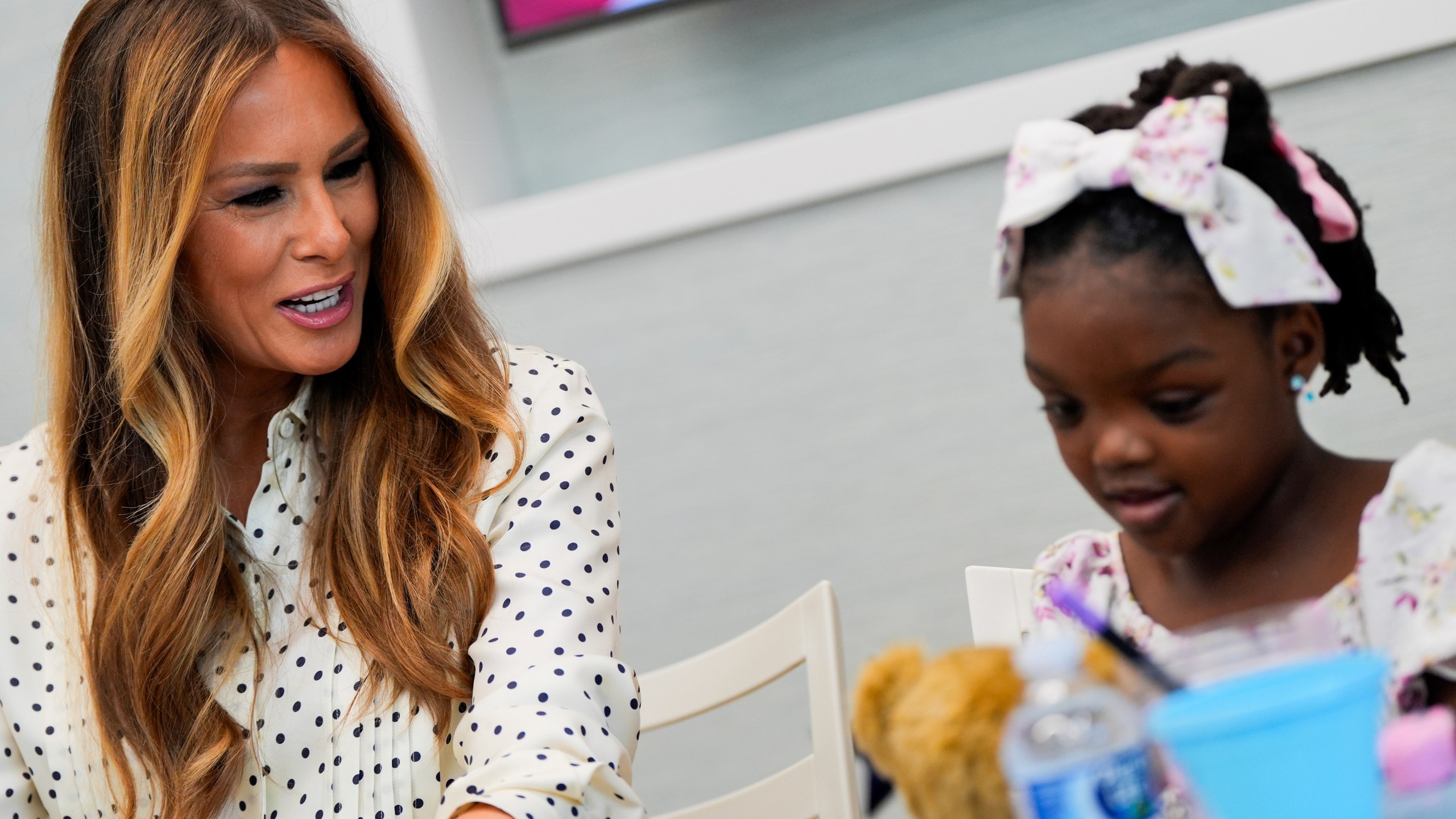 First lady Melania Trump talks with a girl while visiting Children's National Hospital, Thursday, July 3, 2025, in Washington. (AP Photo/Julia Demaree Nikhinson)