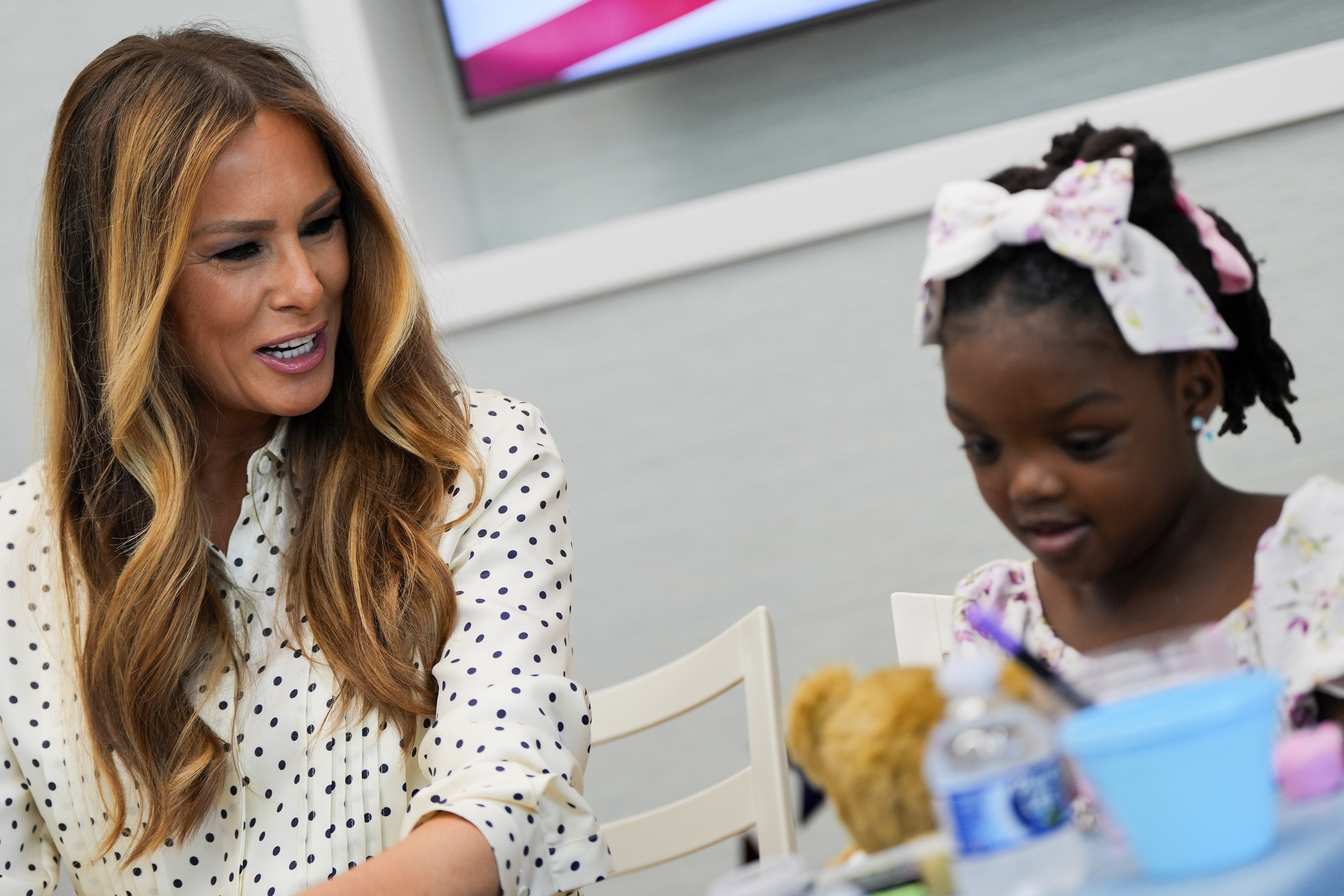 First lady Melania Trump talks with a girl while visiting Children's National Hospital, Thursday, July 3, 2025, in Washington. (AP Photo/Julia Demaree Nikhinson)