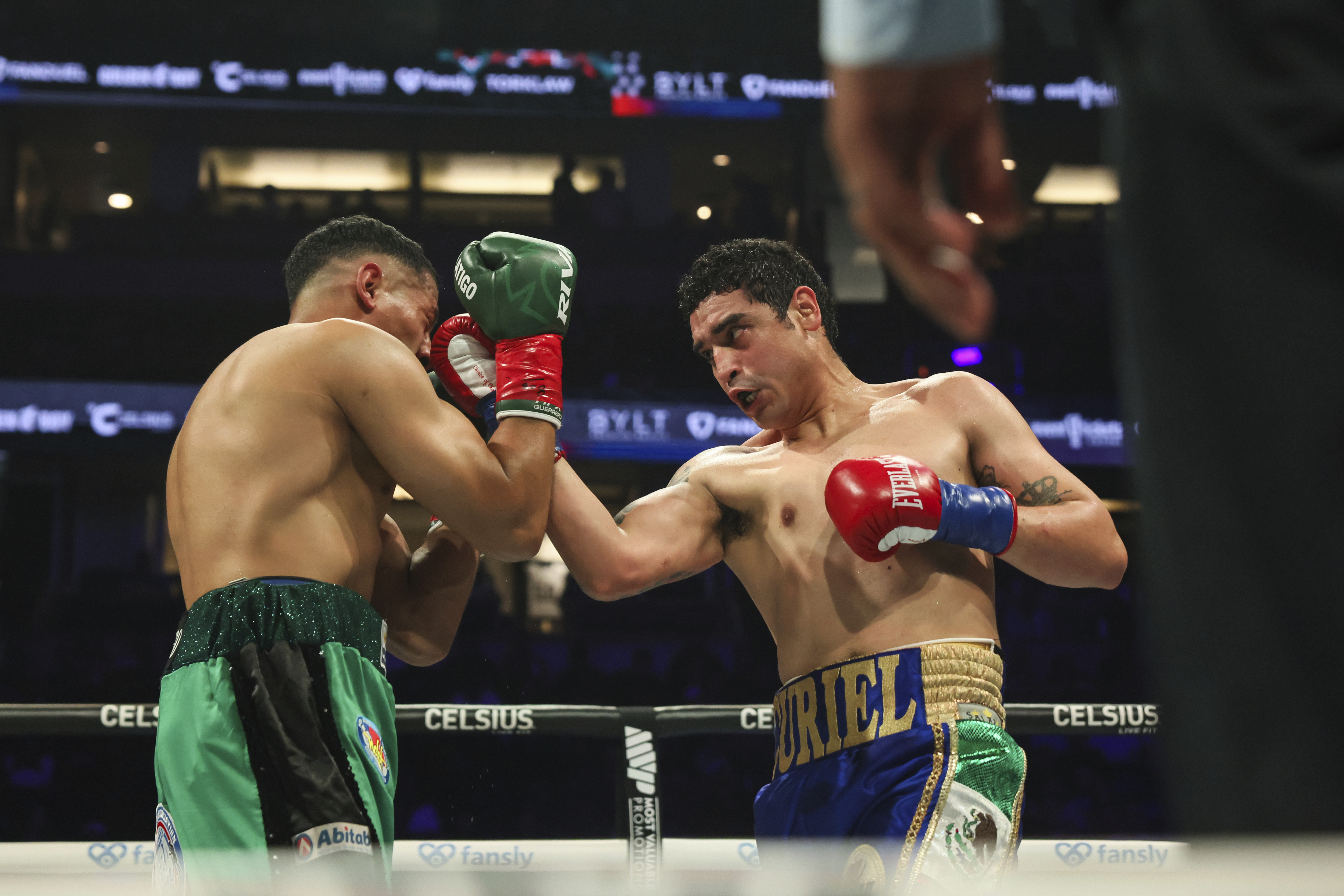 Raul Curiel, right, punches Victor Rodriguez during their Welterweight WBA title eliminator boxing match on Saturday, June 28, 2025, in Anaheim, Calif. (AP Photo/Etienne Laurent)