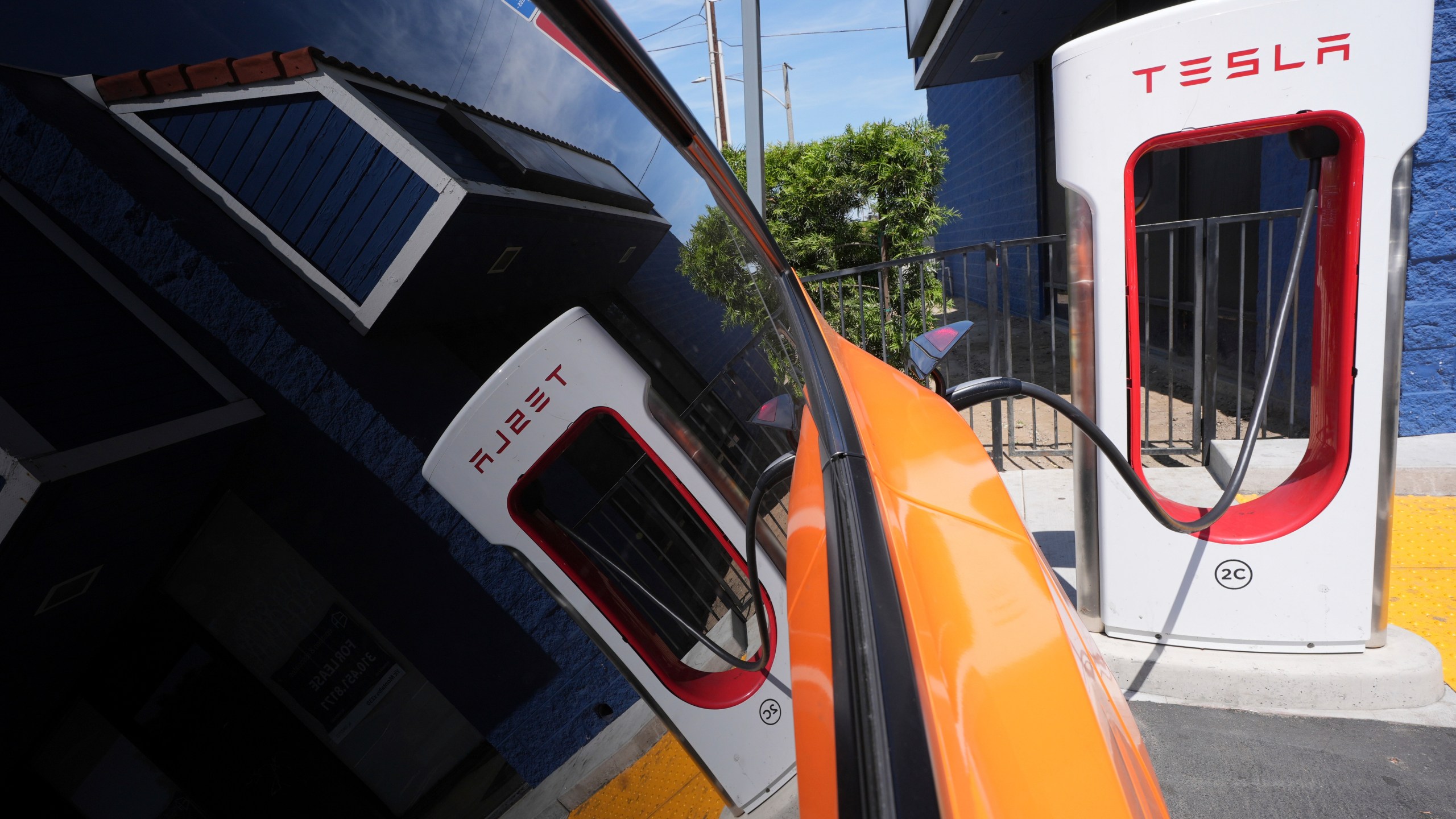 FILE - An electric vehicle charges at a station May 22, 2025, in Long Beach, Calif. (AP Photo/Damian Dovarganes, File)