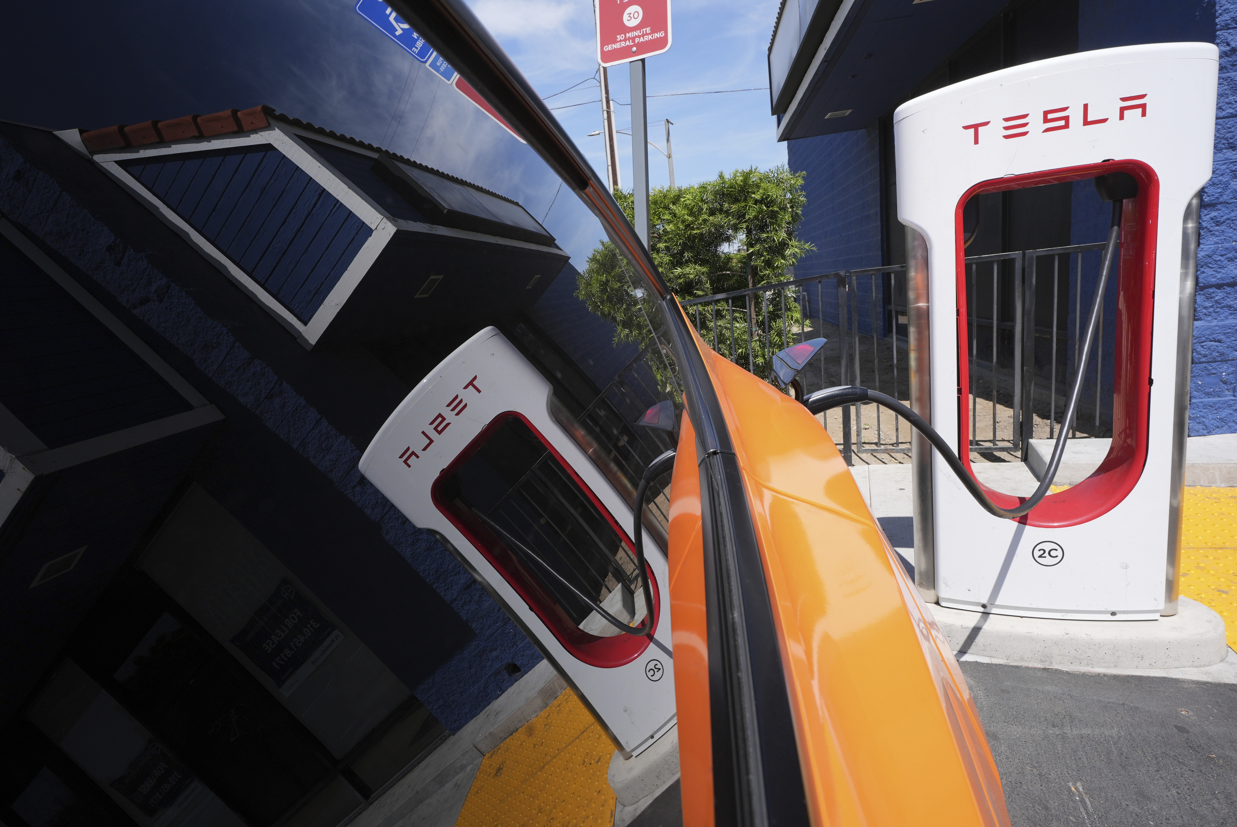 FILE - An electric vehicle charges at a station May 22, 2025, in Long Beach, Calif. (AP Photo/Damian Dovarganes, File)